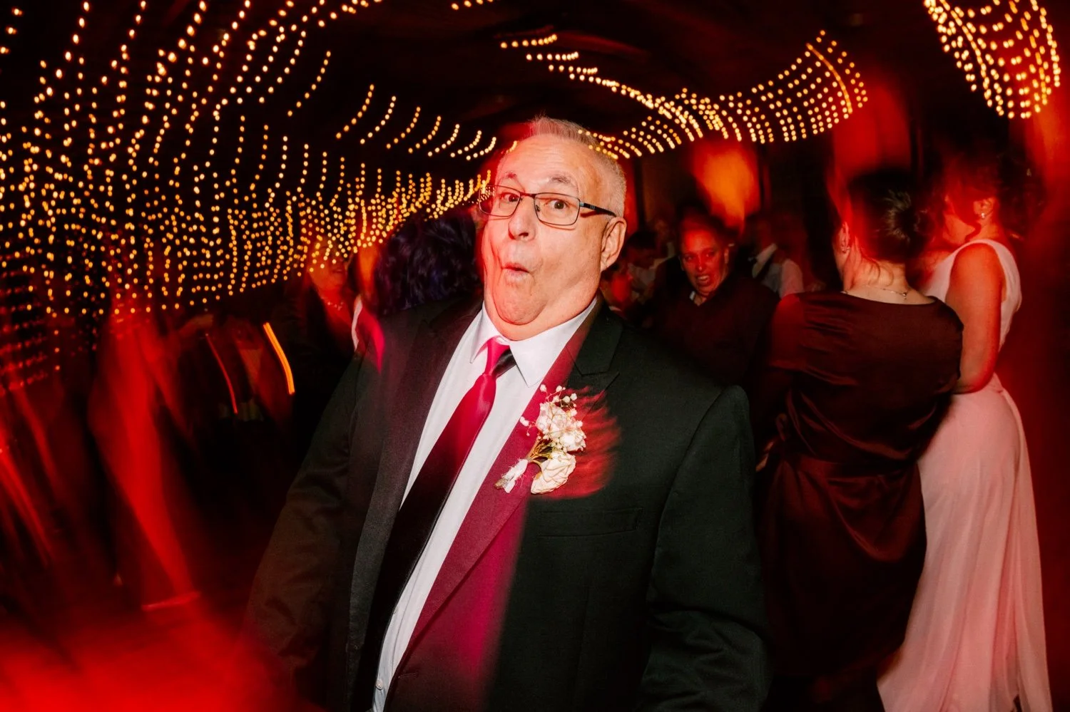  father of the bride being silly during wedding reception and string lights at city winery hudson valley 