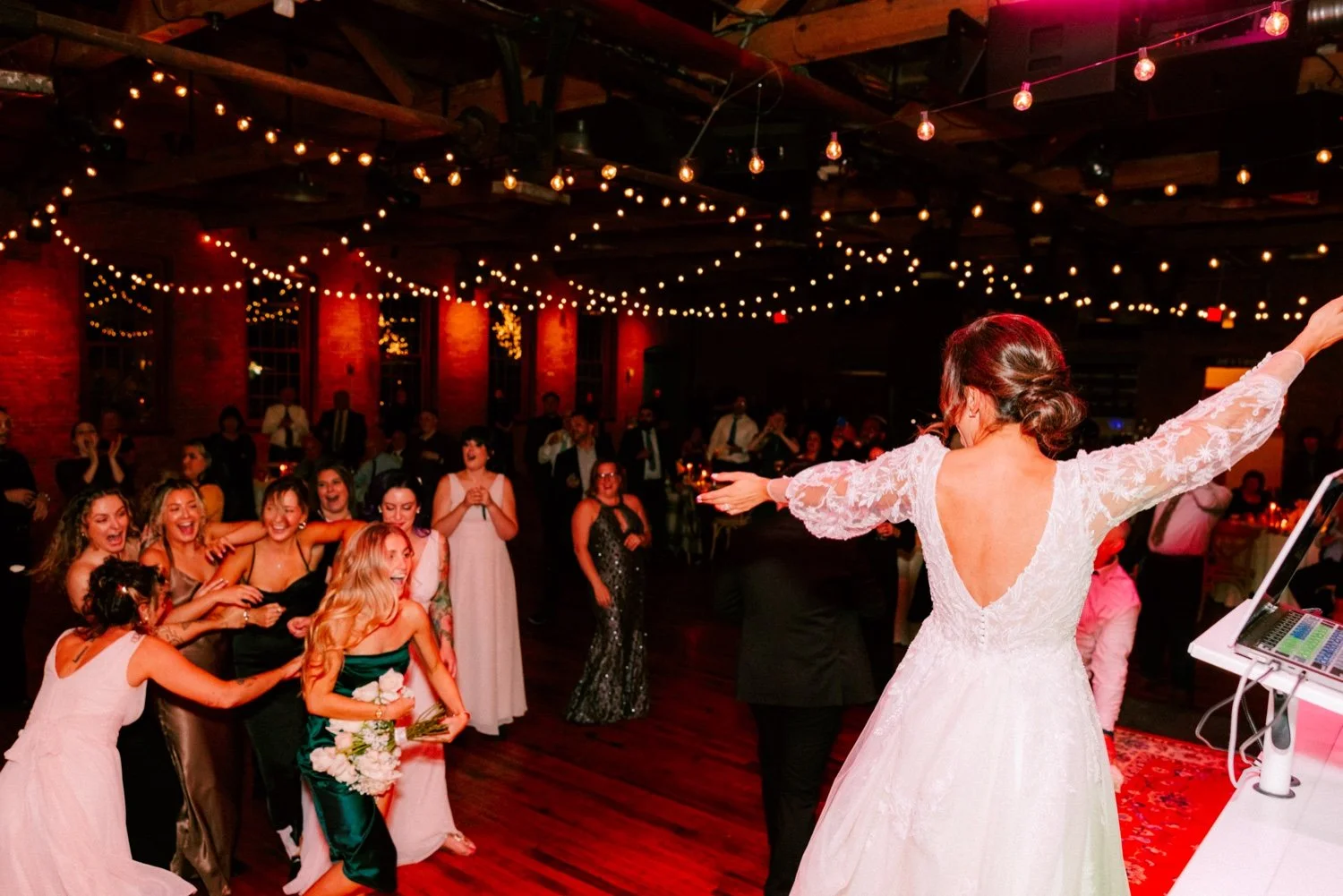  wedding guest catches bouquet during winter wedding reception at city winery hudson valley 