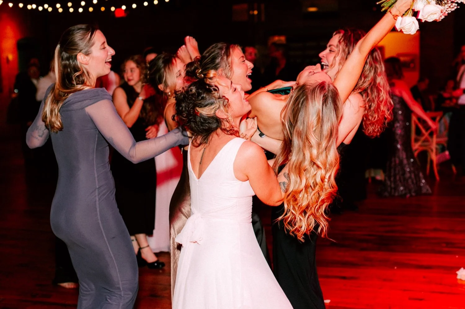  girls lift guests who caught the bouquet in celebration at city winery hudson valley 