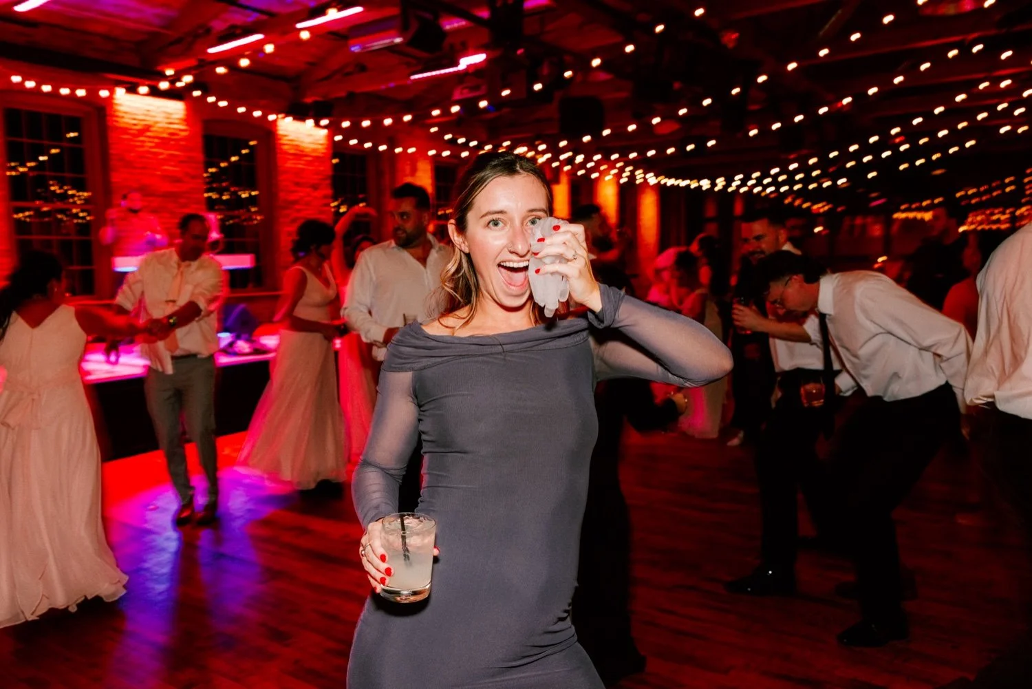  guests holds plastic glove with ice in it to her face after getting injured during the bouquet toss  