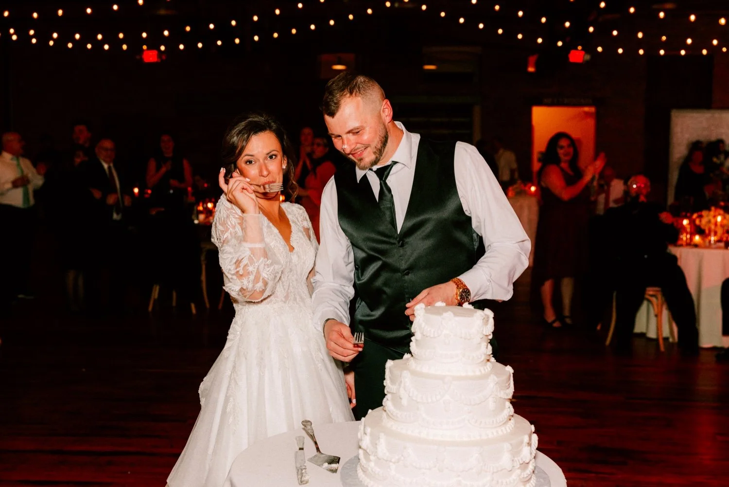  bride and groom cut cake during their winter wedding reception at city winery hudson valley 