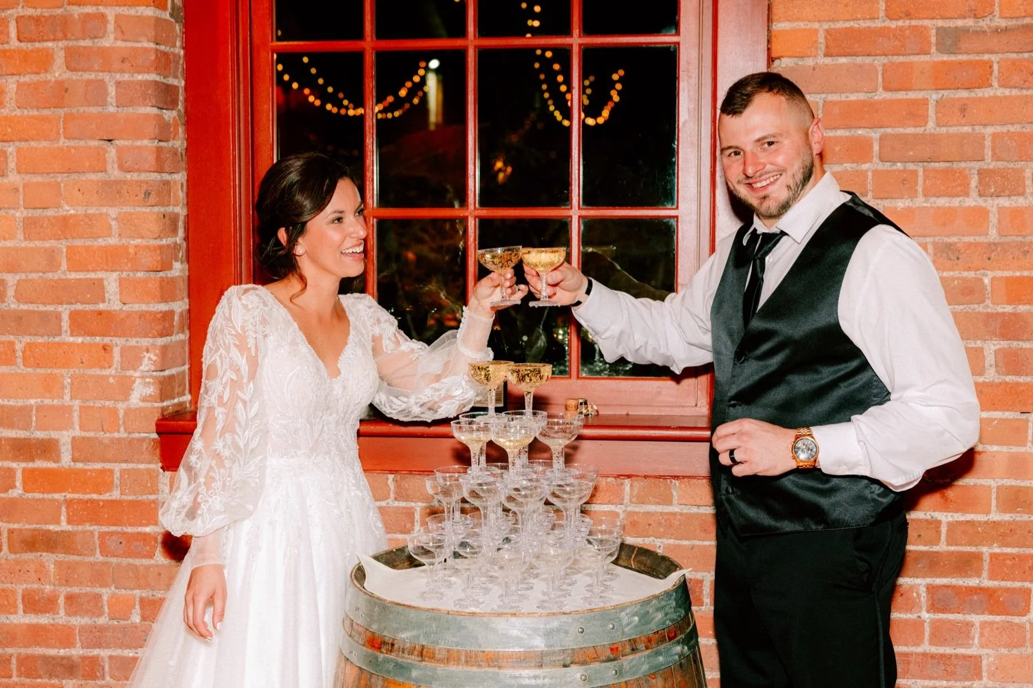  wedding couple cheers champagne at their tower at city winery hudson valley 