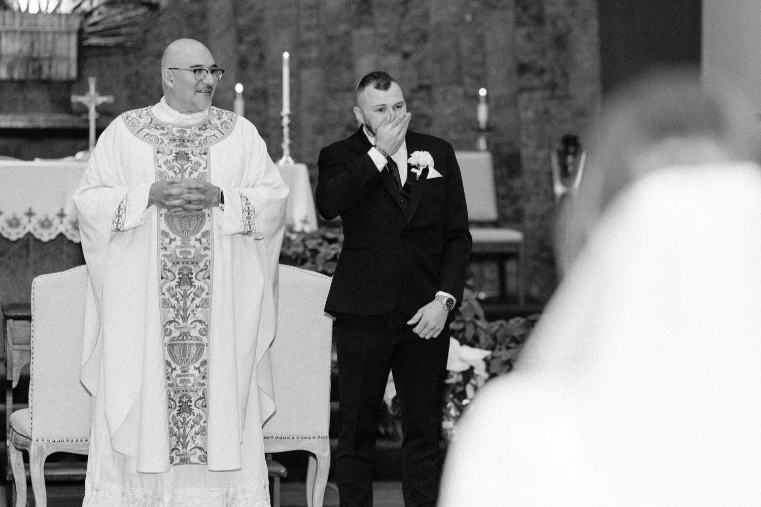  groom crying while bride walks down the aisle  