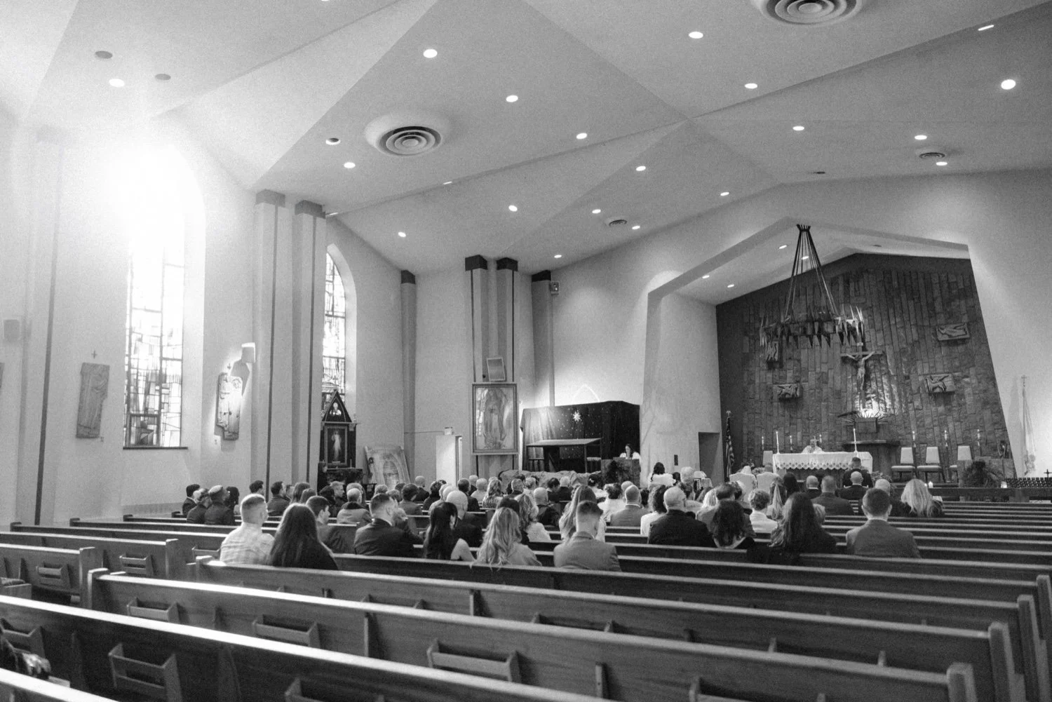  black and white photo of guests during church wedding ceremony in newburgh ny 