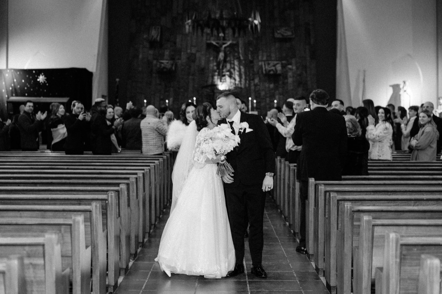  wedding couple kiss in aisle during their church ceremony recessional in newburgh ny 