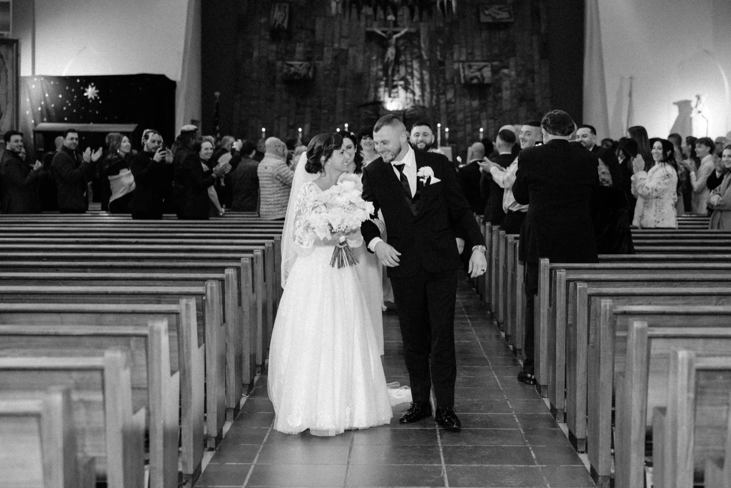  black and white wedding photograph of couple walking down church aisle in newbrugh, ny 