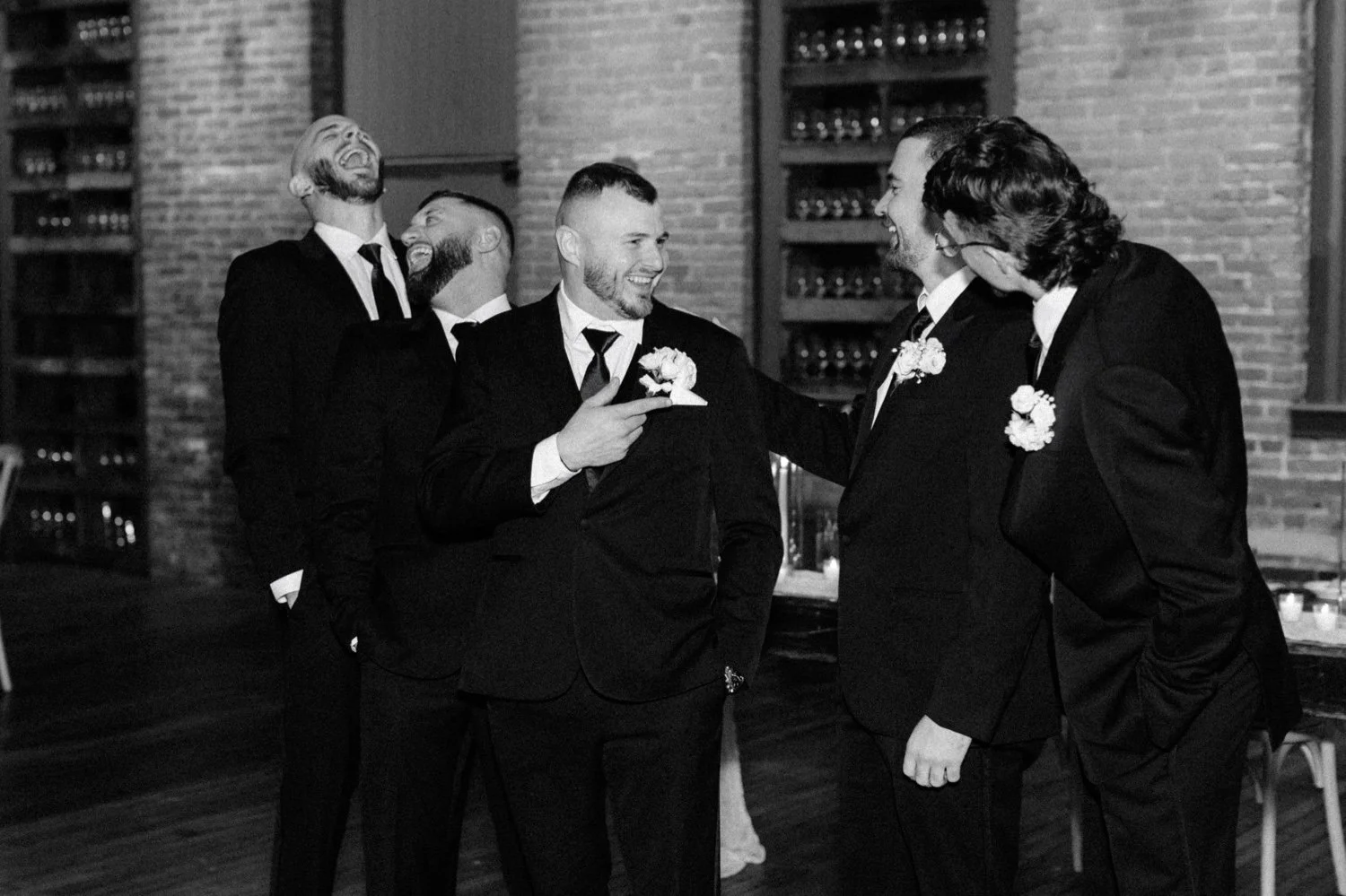  groomsmen laugh on winter wedding day inside city winery hudson valley 