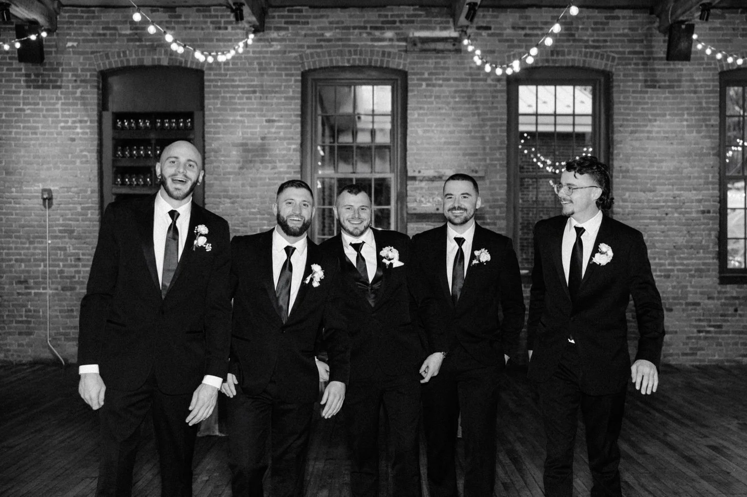  groomsmen walking inside city winery hudson valley on winter wedding day 