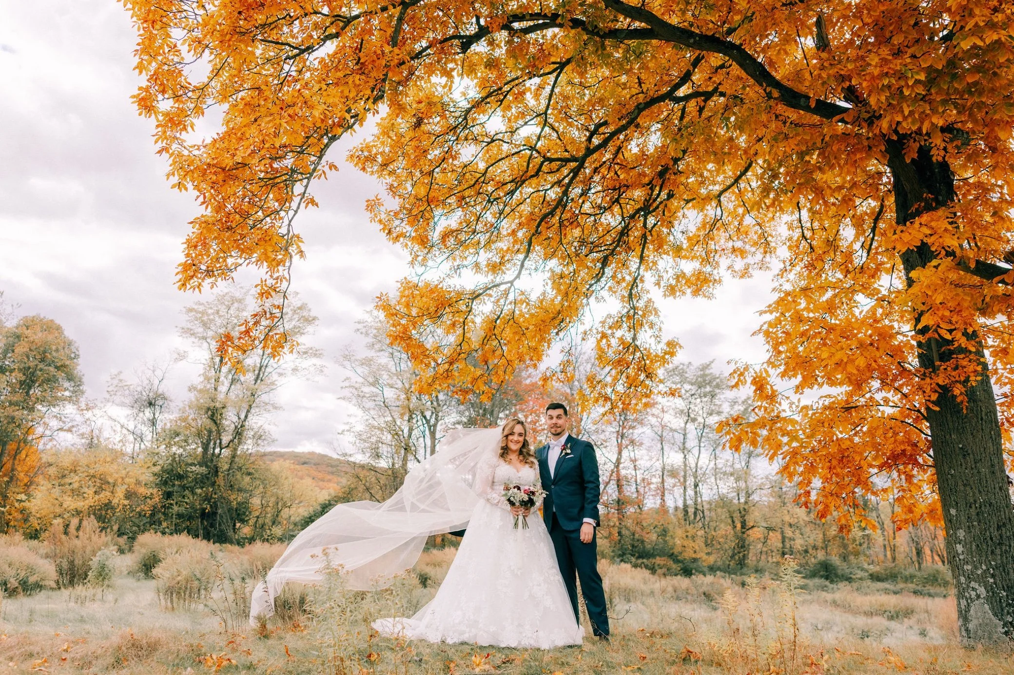  autumn wedding at the garrison couple photographed under large tree 