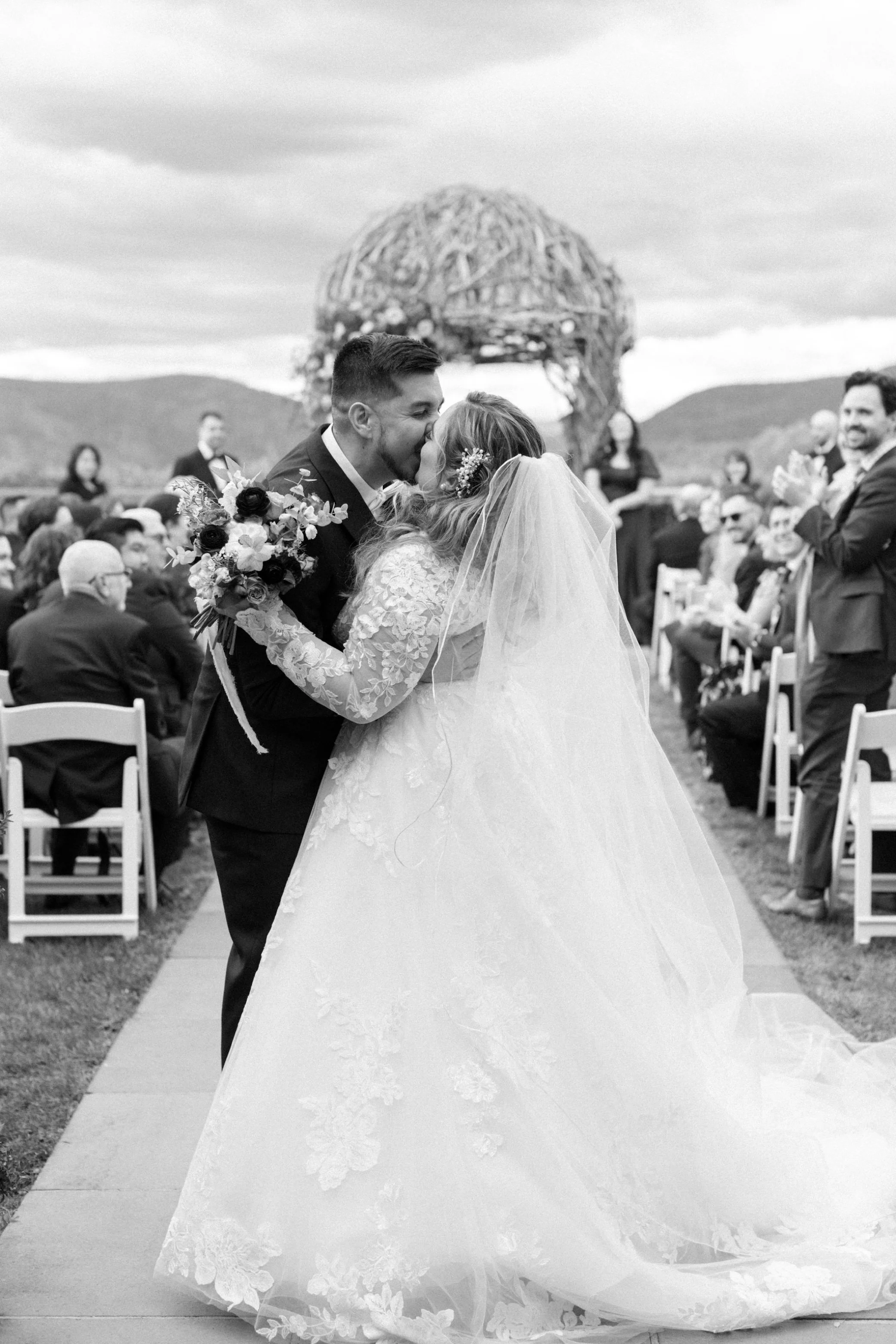  black and white wedding photograph of aisle kiss at the garrison 