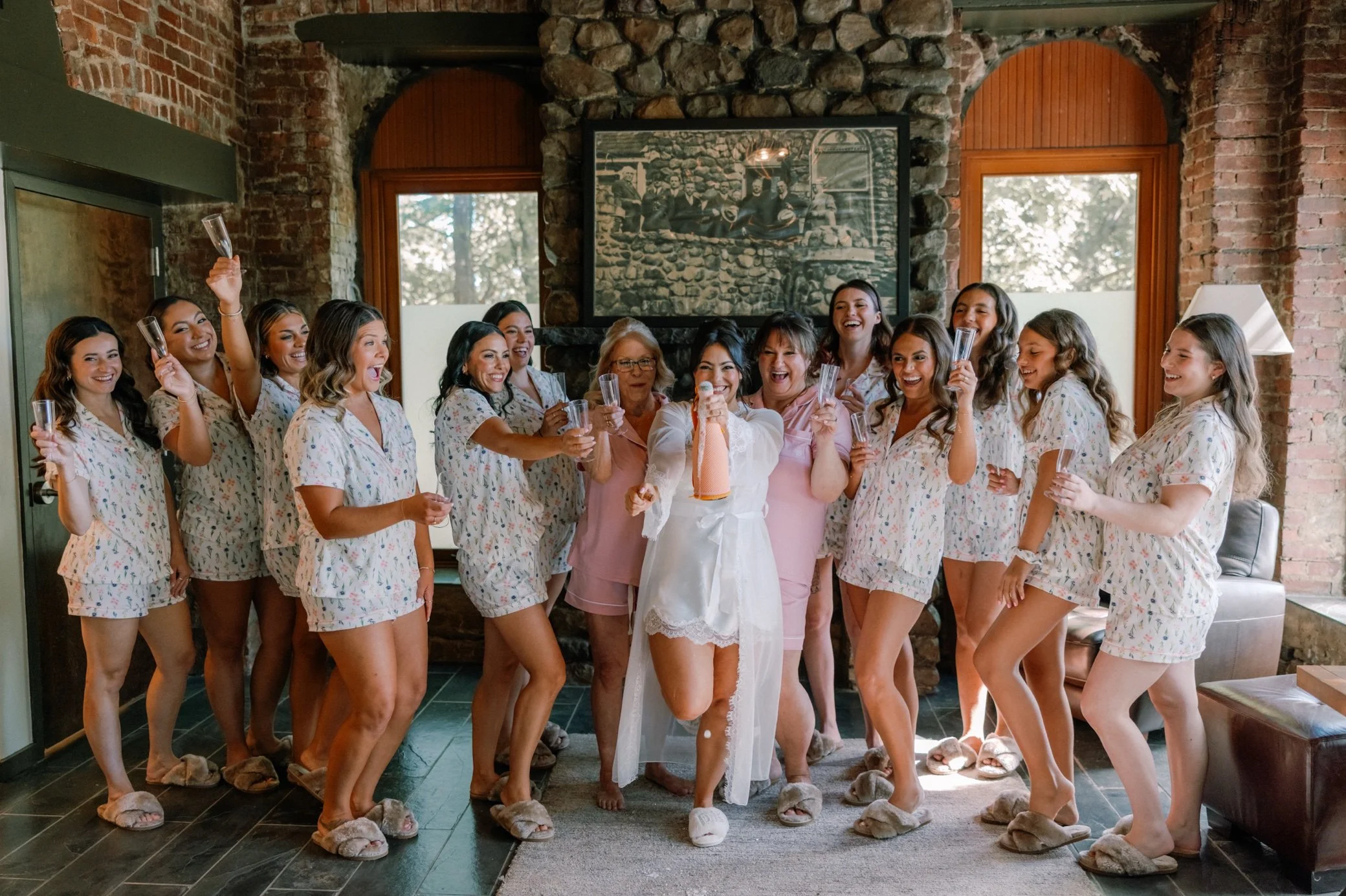  bridesmaids popping champagne at the bridal suite in brotherhood winery 