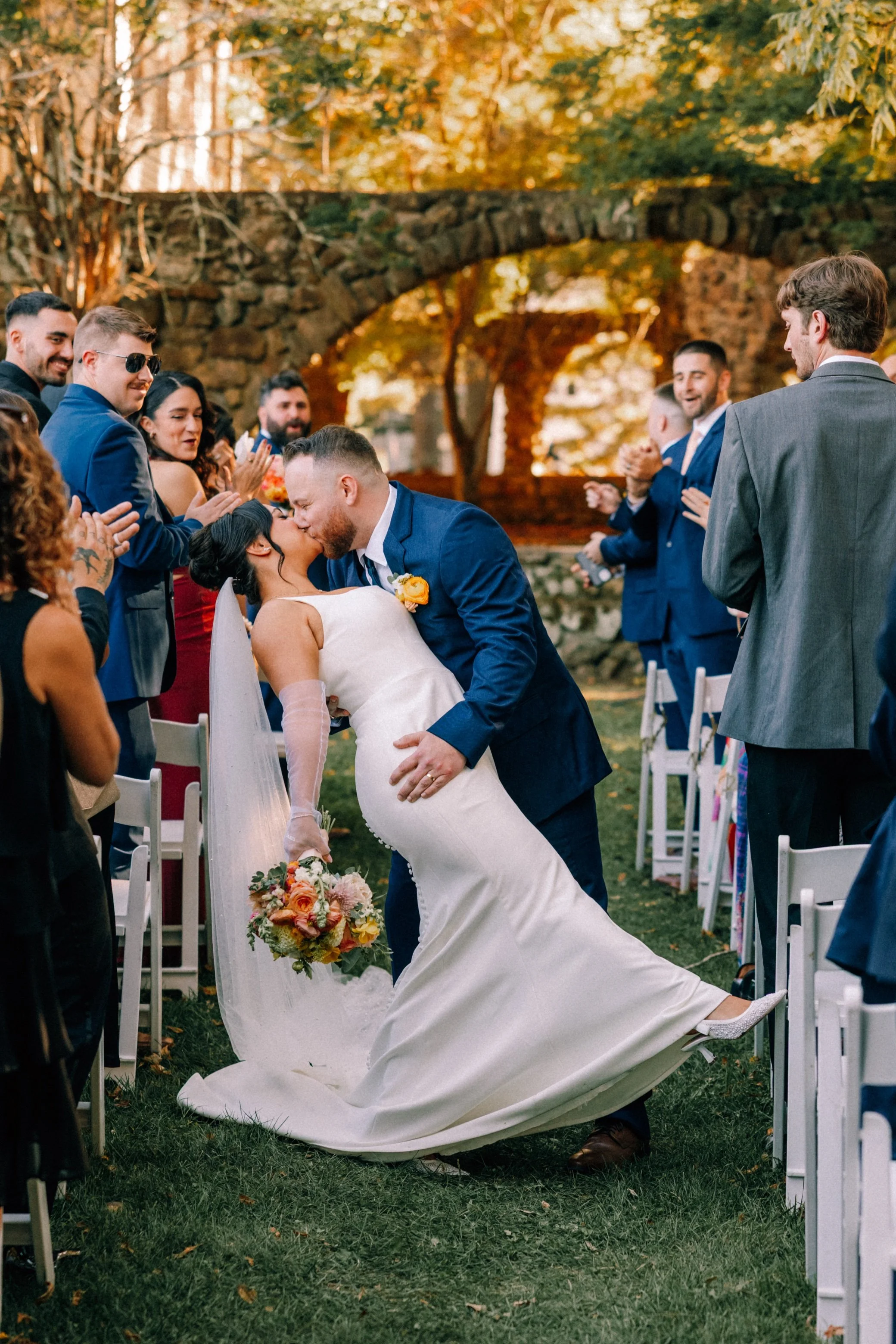  wedding couple kiss in the aisle after their ceremony at brotherhood winery 