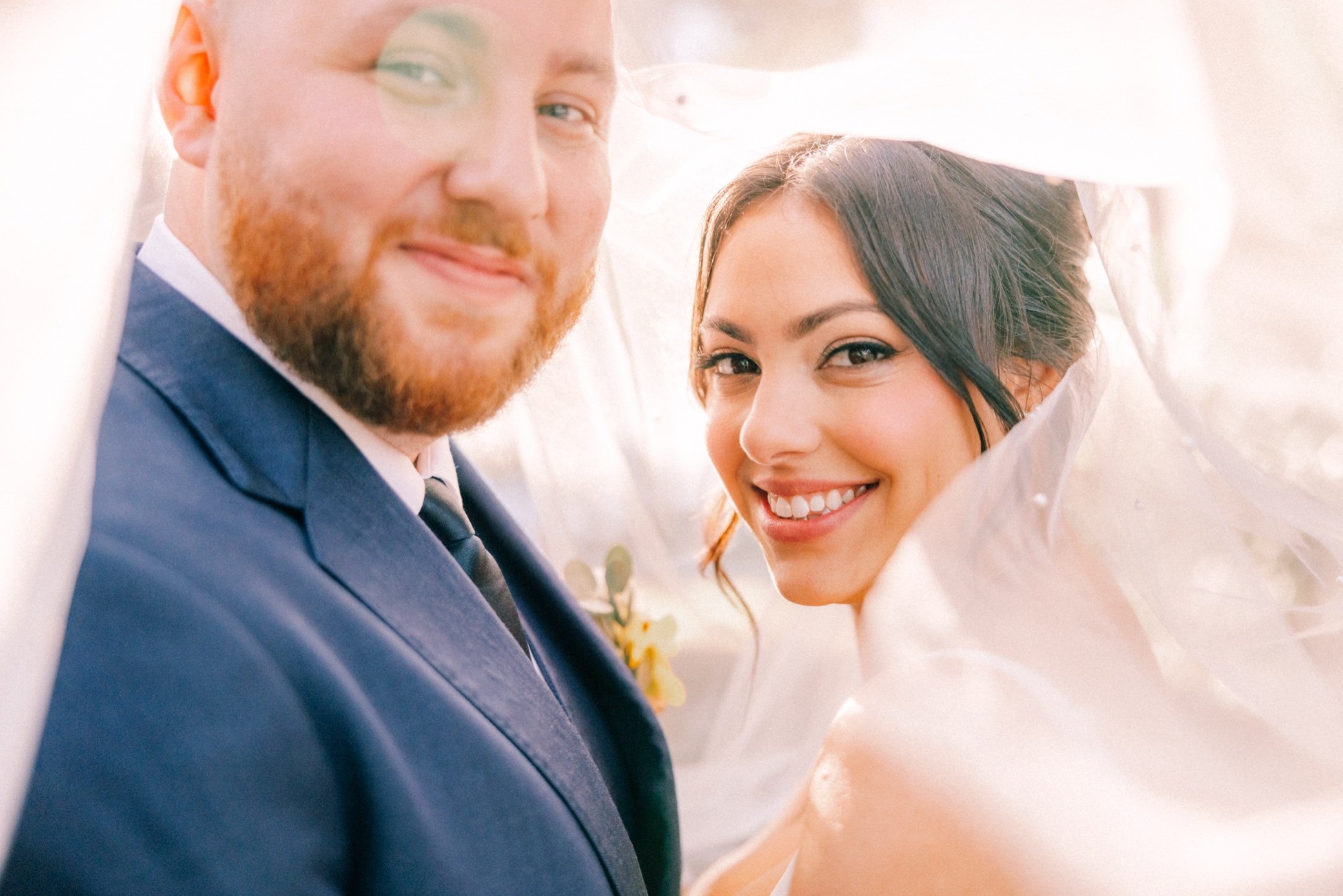  wedding couple under veil at brotherhood winery 