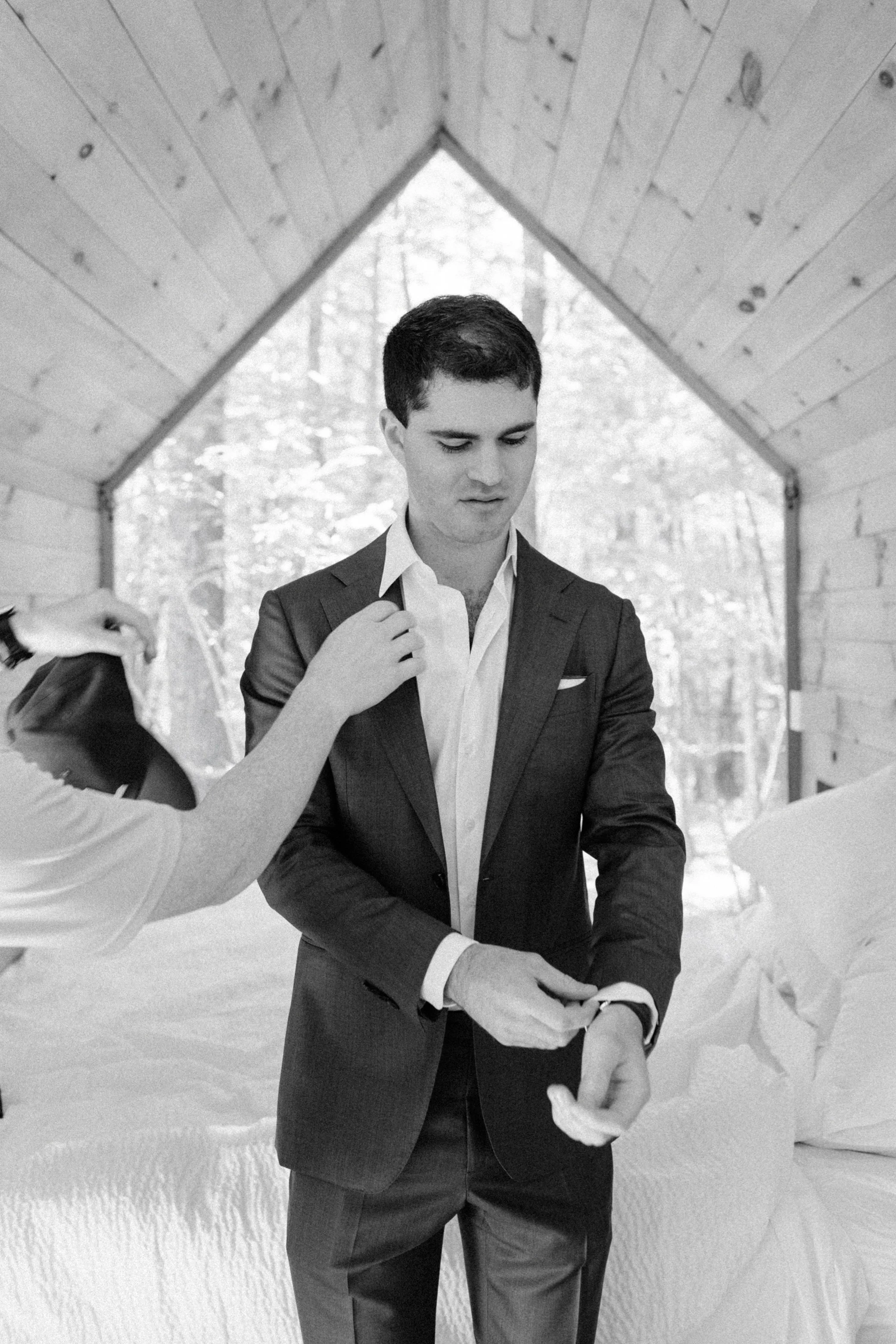  groom getting ready in the cabins during his wedding day at gather greene in the hudson valley 