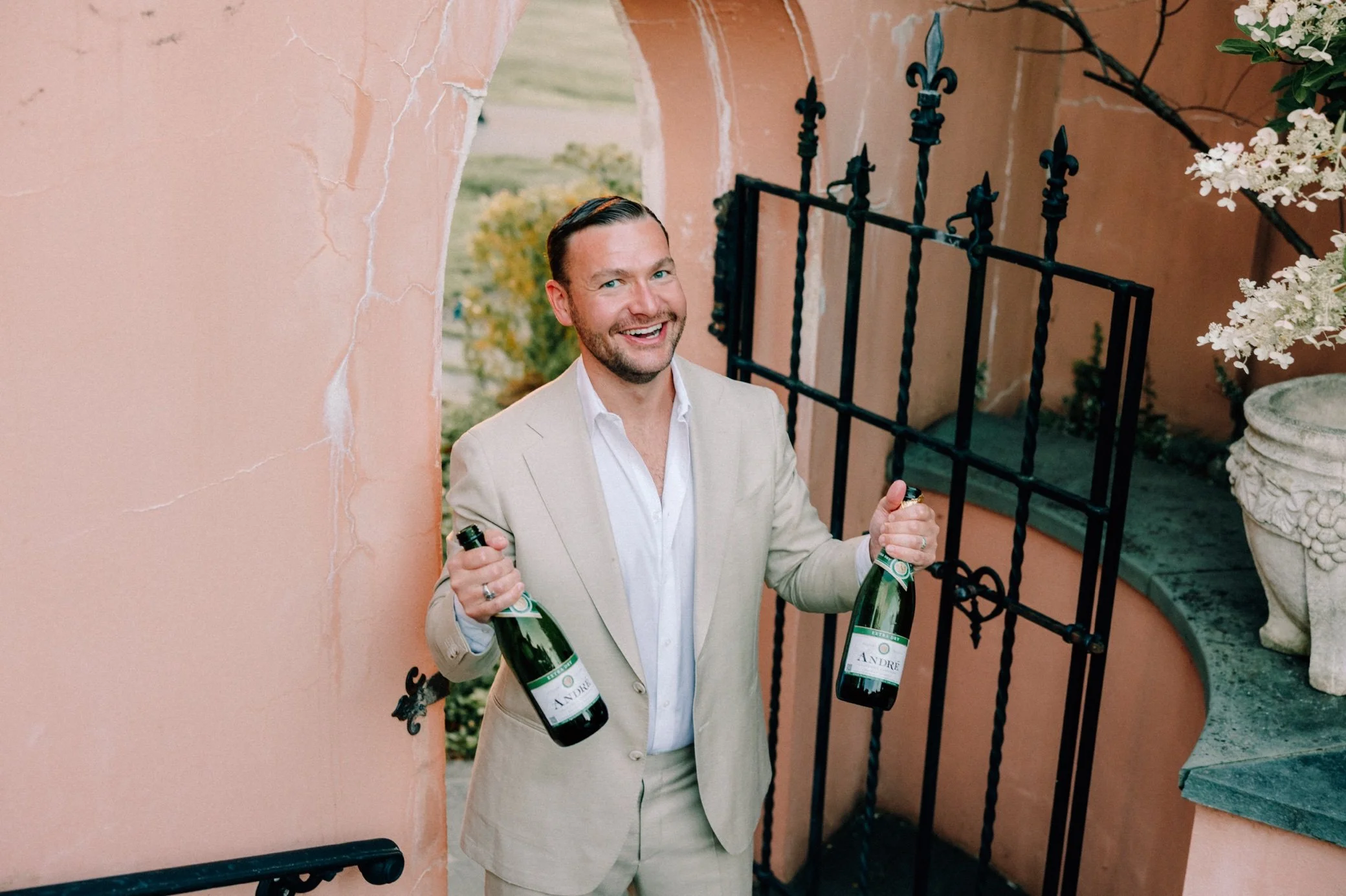  groom holding champagne at glenmere mansion wedding weekend welcome party 