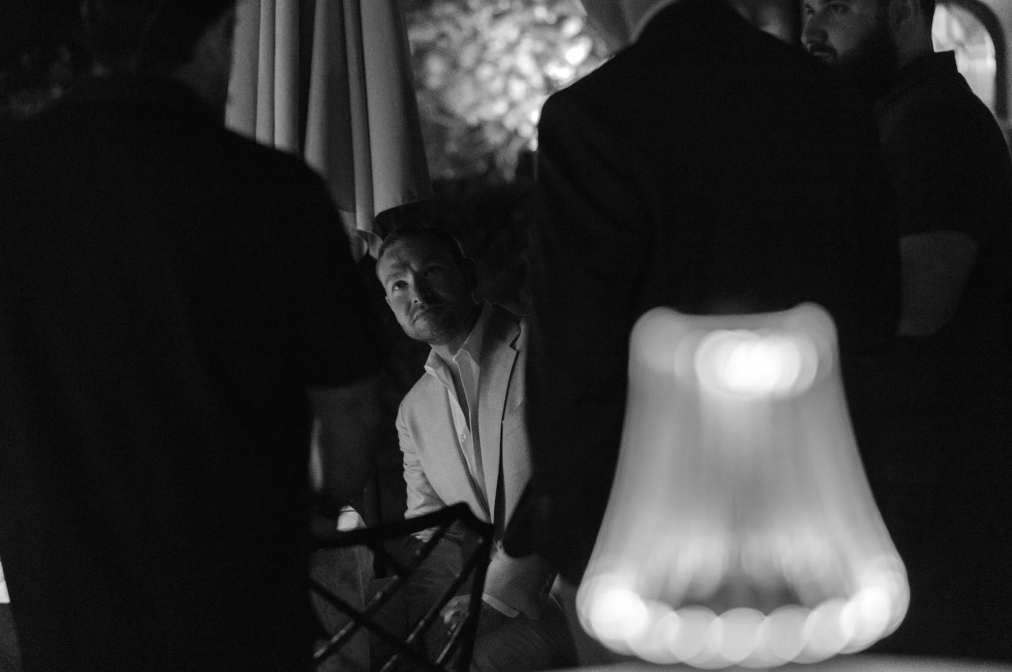  night photograph of groom during wedding welcome party at glenmere mansion 