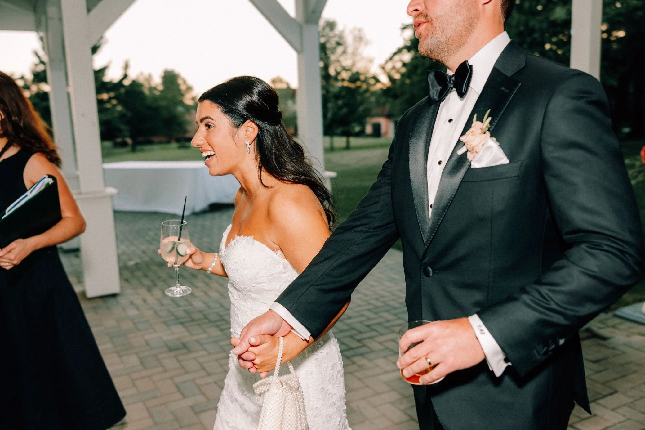  wedding couple walking to reception reveal in the barn at glenmere mansion 