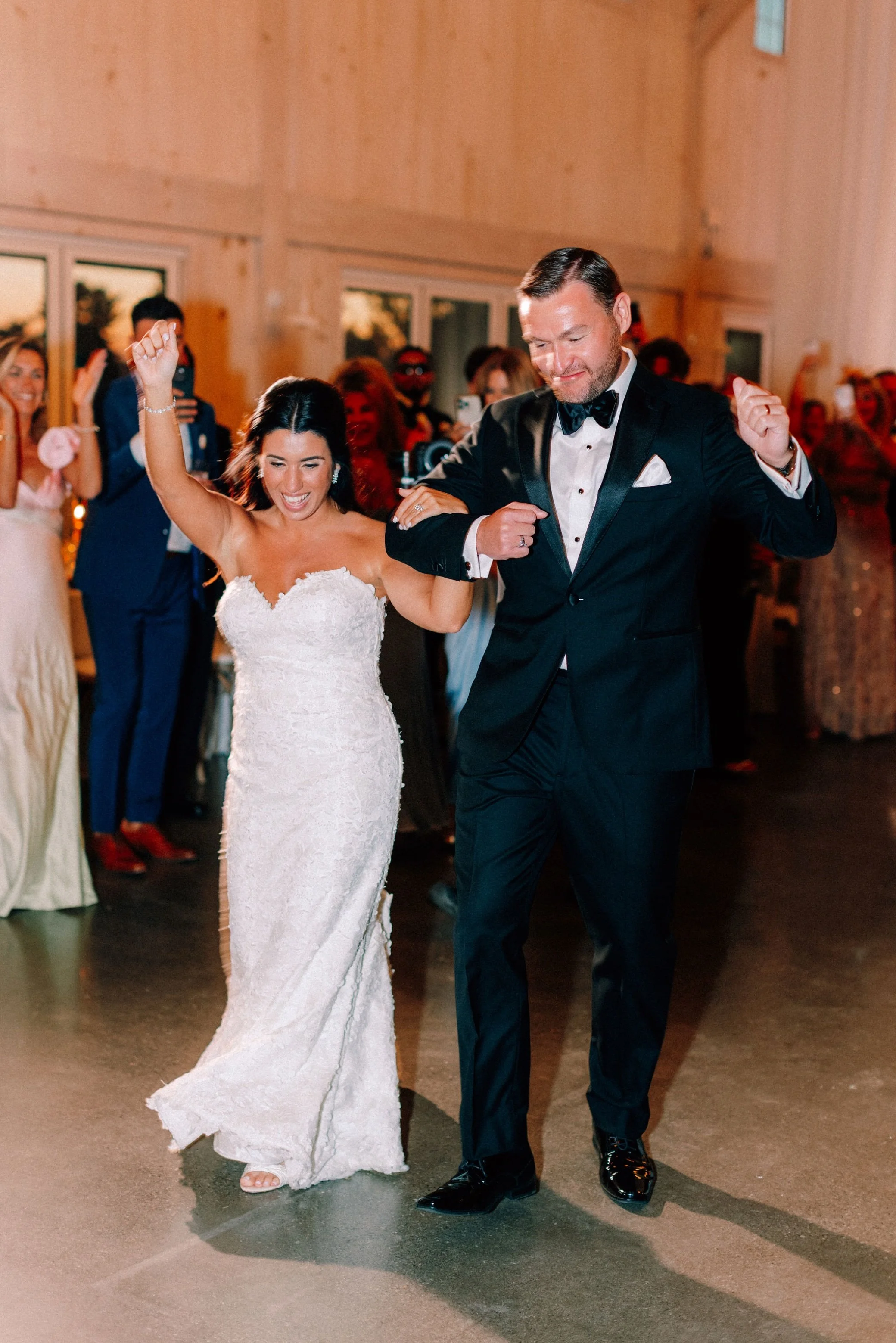  wedding couple enter wedding reception at glenmere mansion 