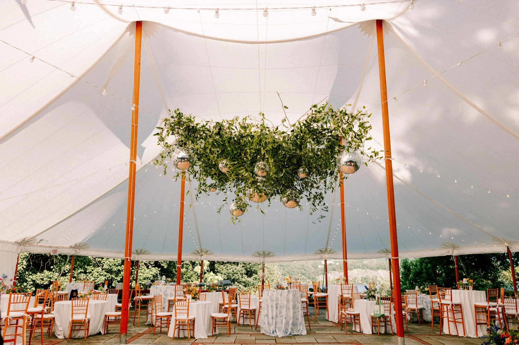  disco ball and greenery in tented hudson valley reception at buttermilk falls 