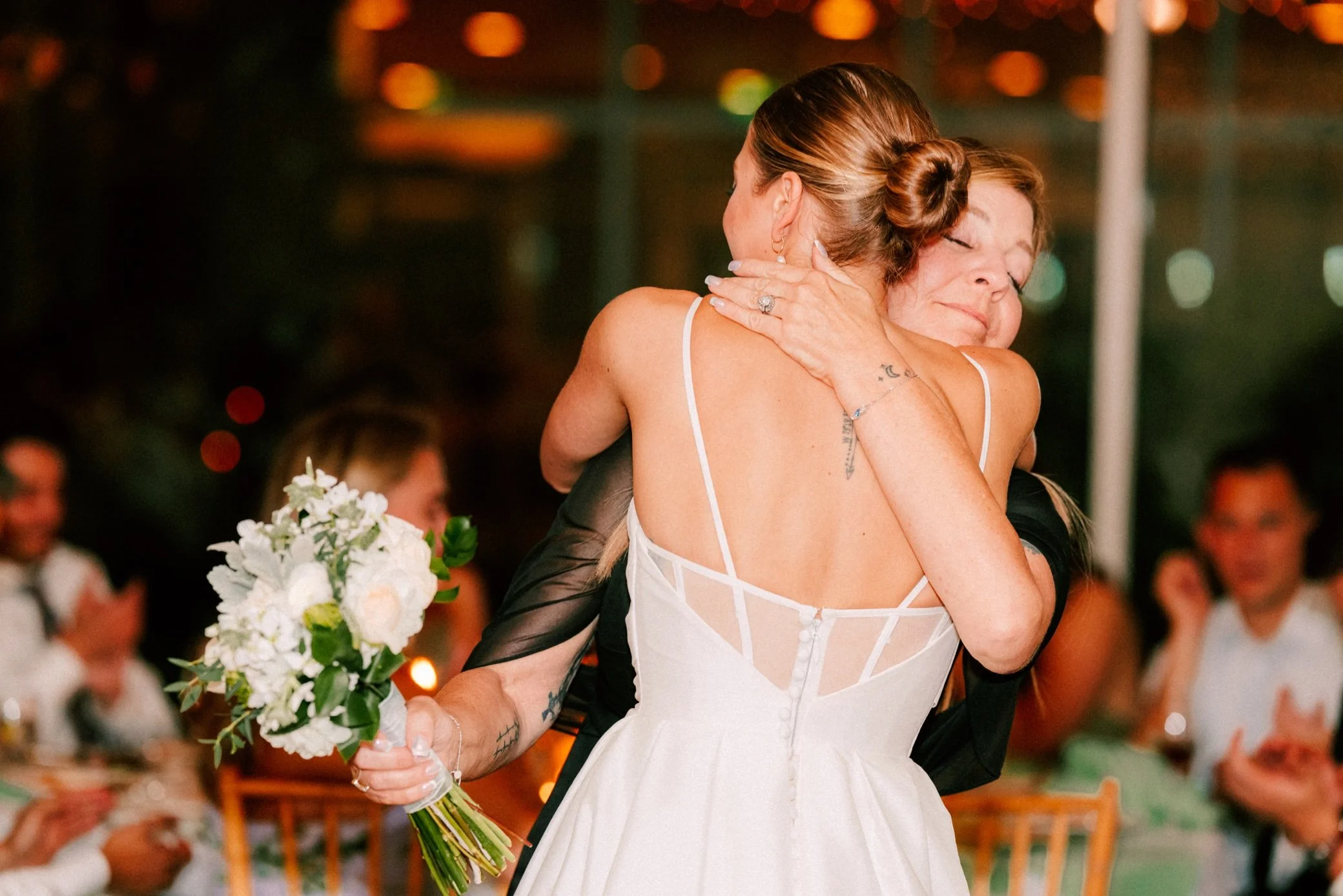  bride gives mom her bouquet at the garrison 
