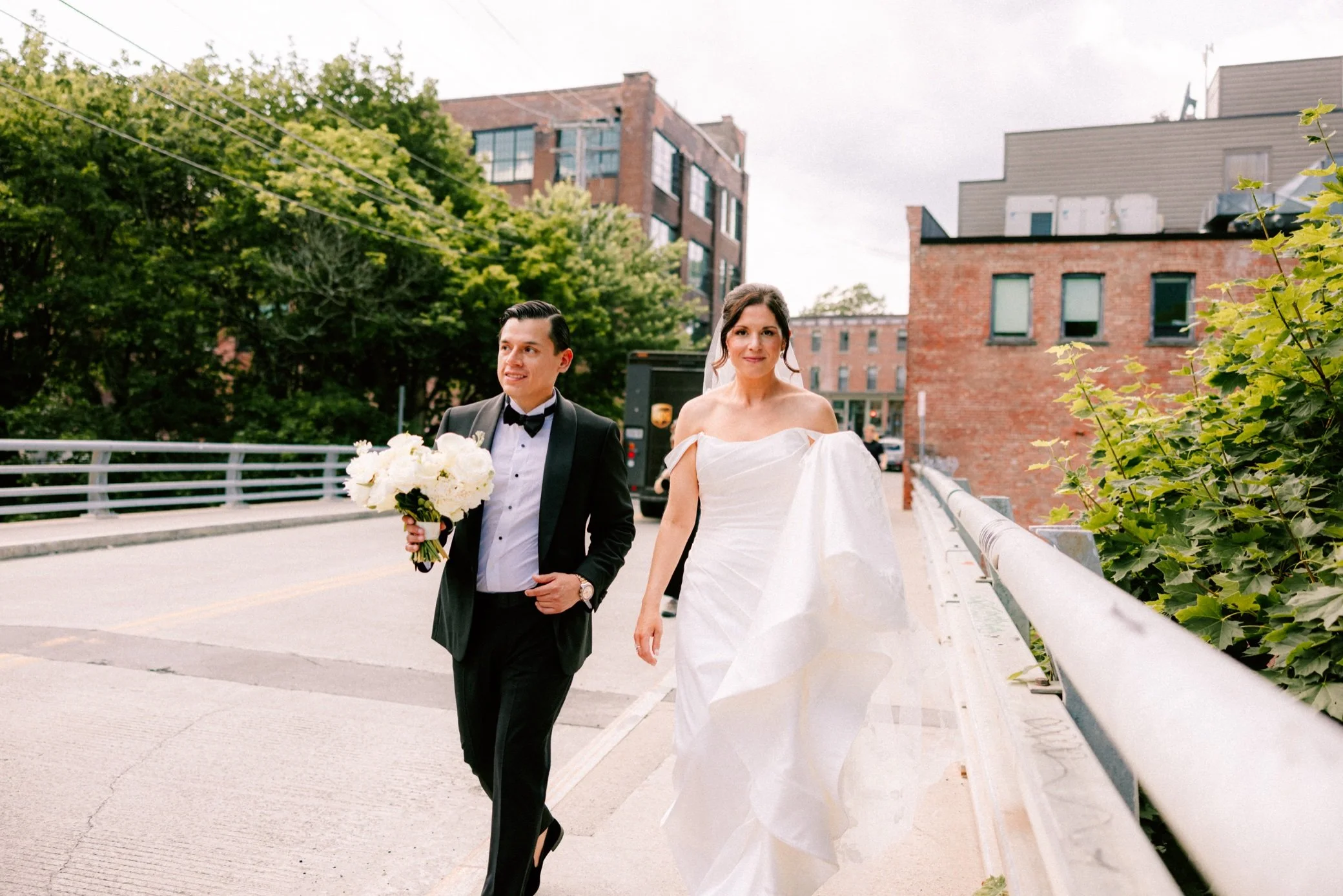  the roundhouse wedding couple walking across bridge  