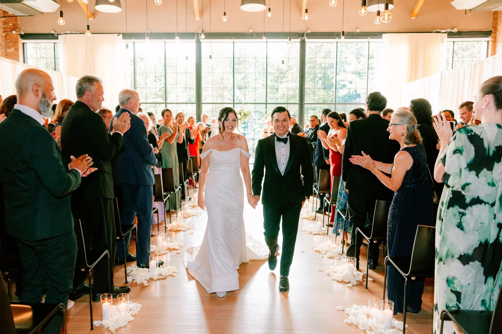  couple walking down aisle at indoor wedding ceremony at the Roundhouse 