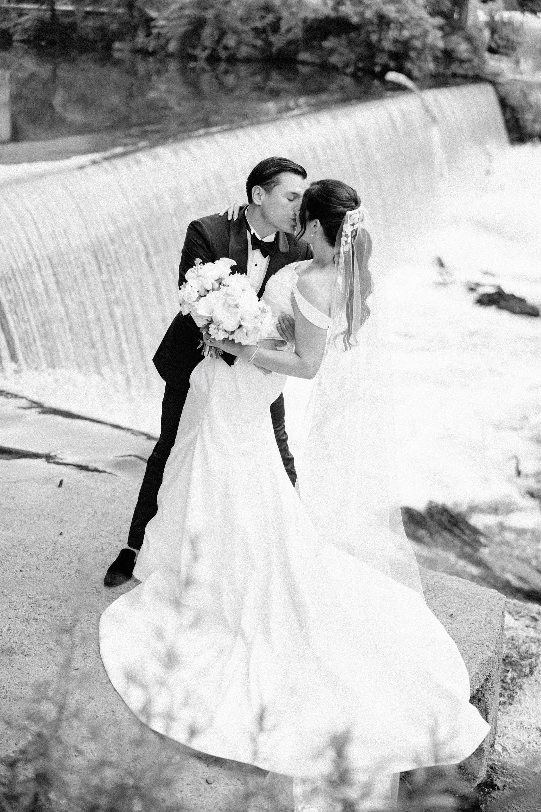  the roundhouse wedding film photograph of couple in front of waterfall in beacon ny 