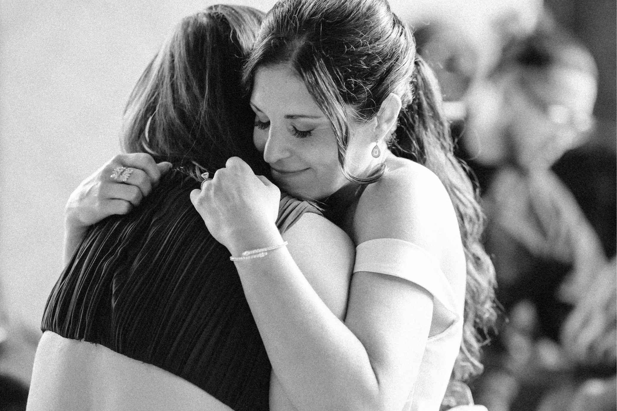  the roundhouse wedding film photograph of bride hugging guest  