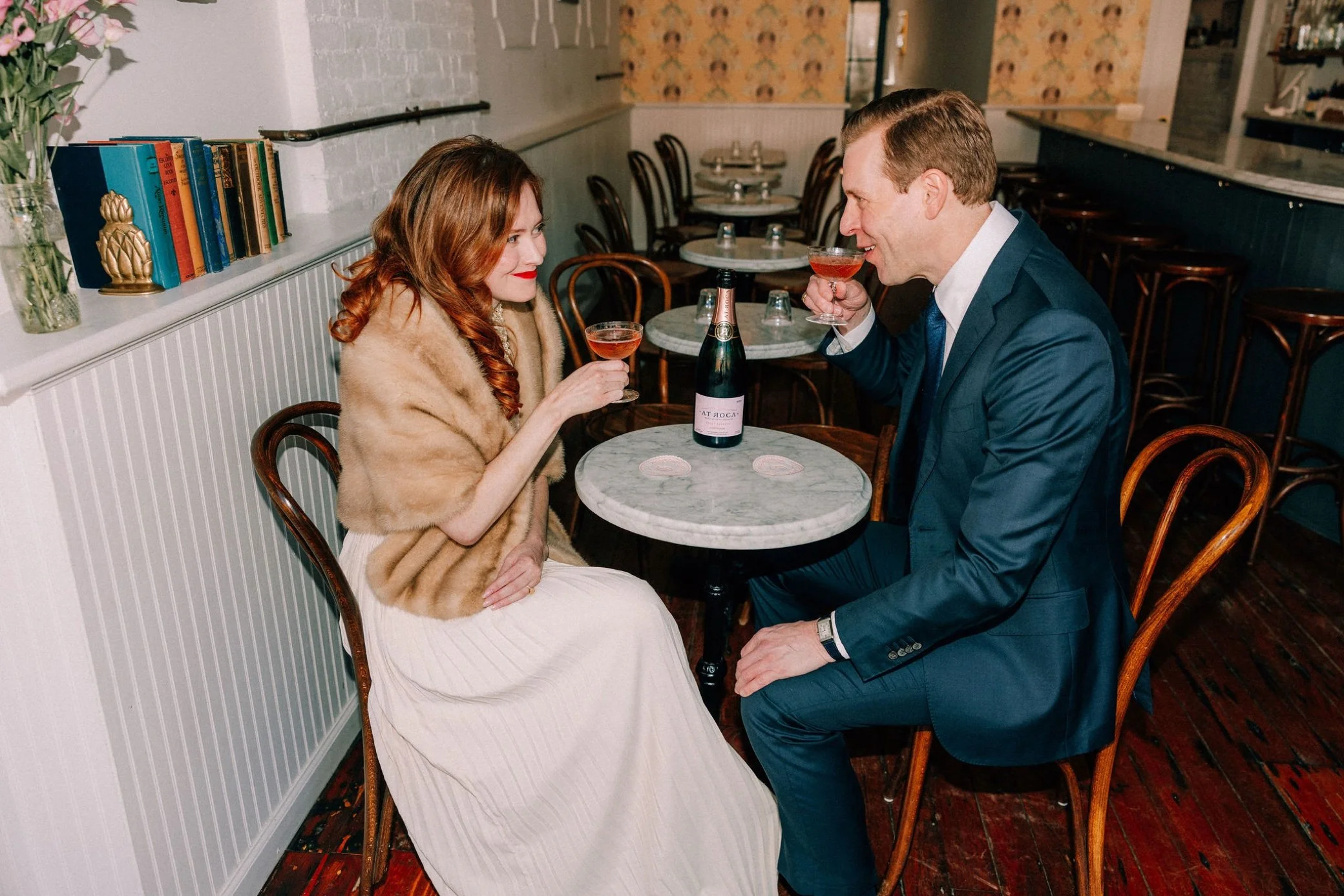  couple share wine during their engagement photo shoot at brunette wine bar in kingston, ny 