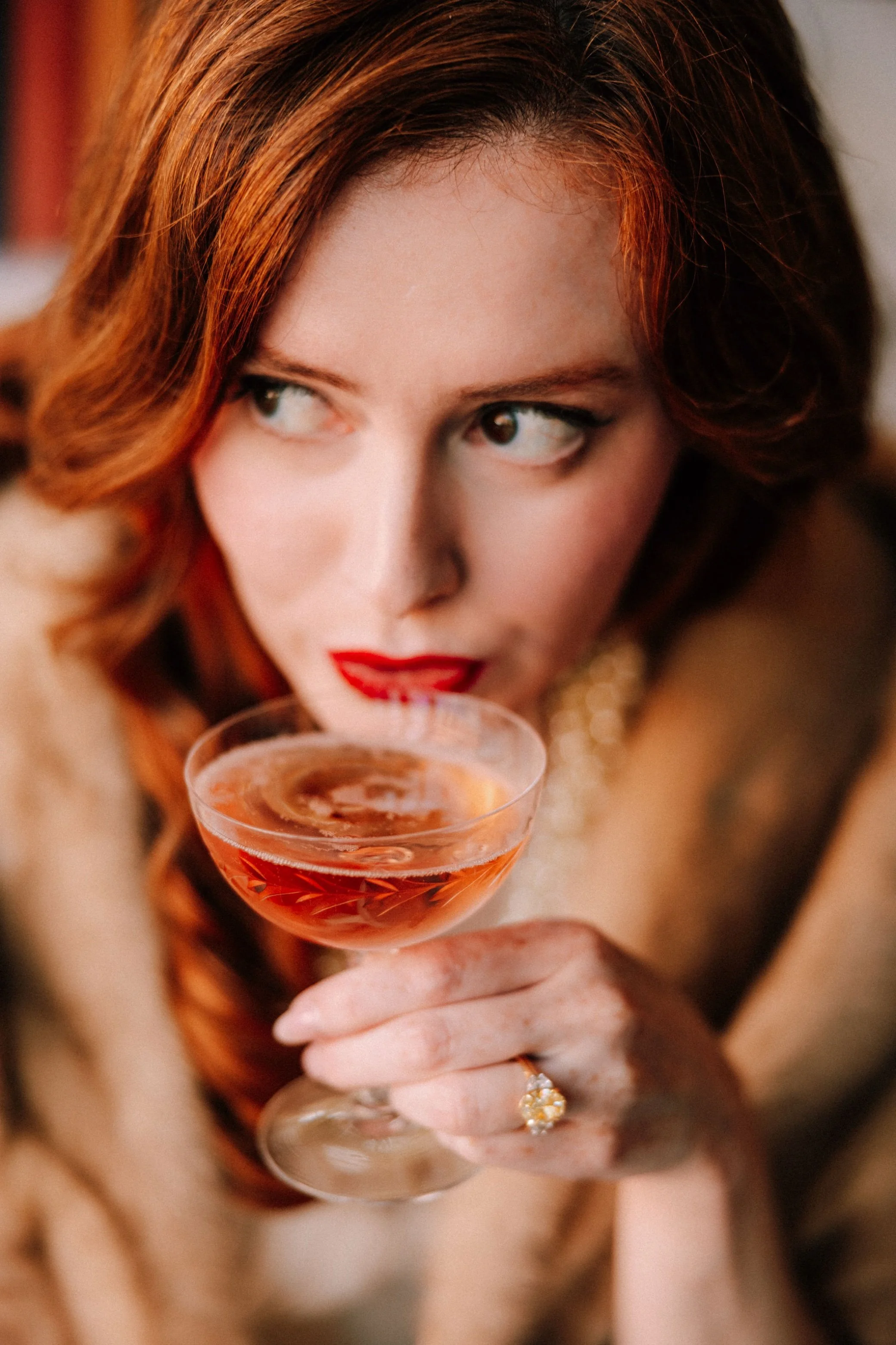  future bride sipping champagne during her engagement photography shoot at brunette wine bar in kingston, ny 