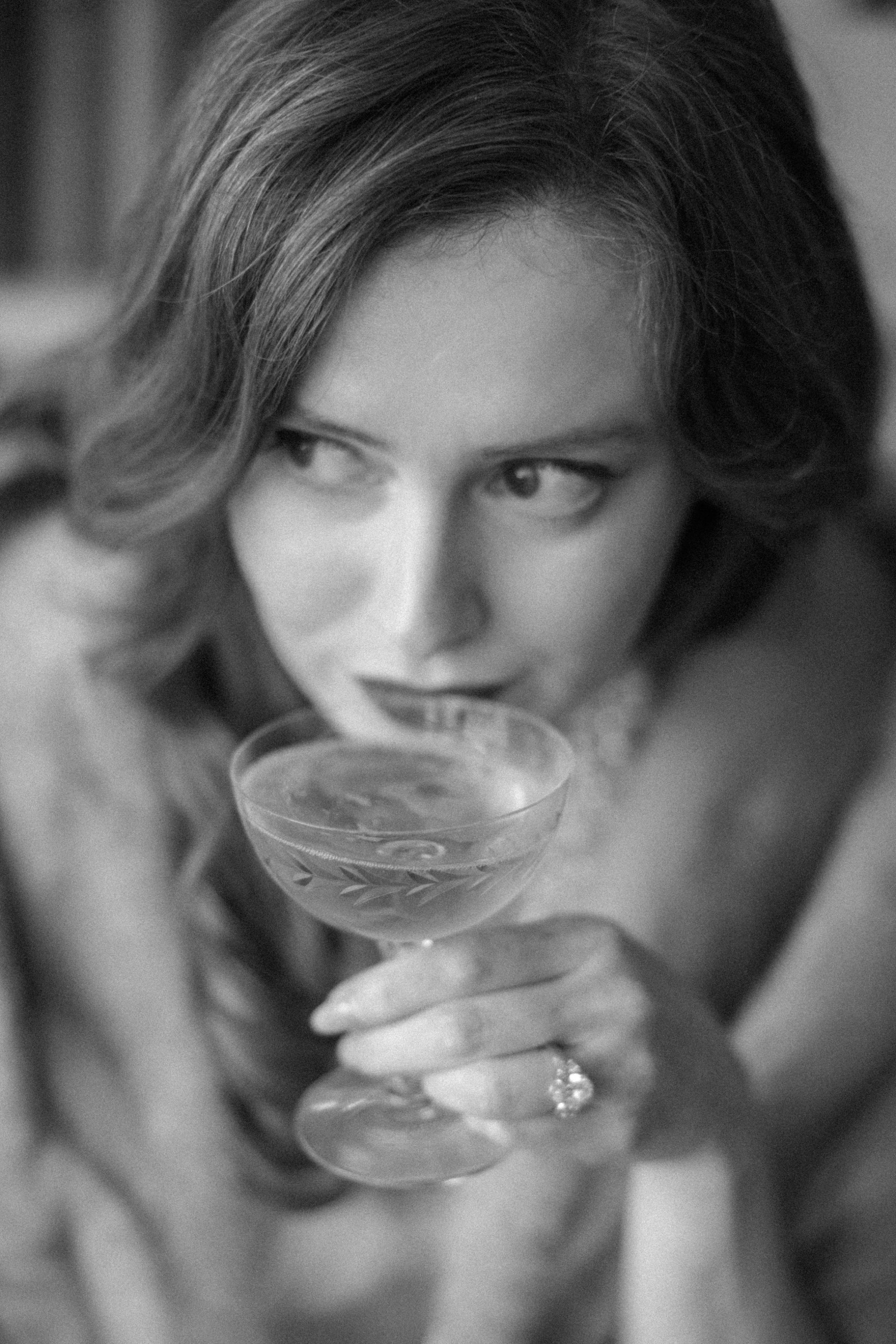  future bride in old hollywood glamour sips champagne from a vintage coupe at brunette wine bar 