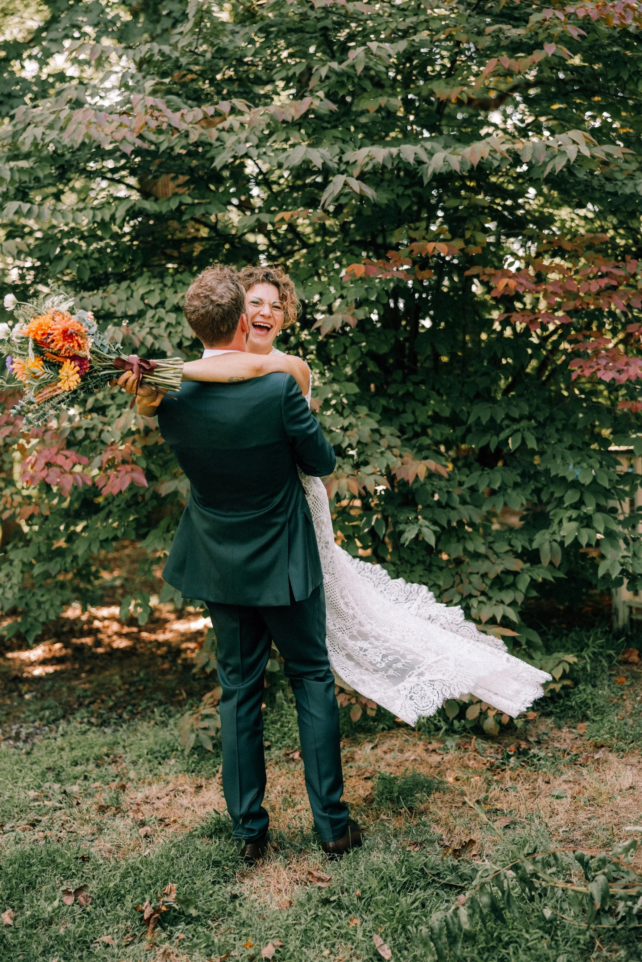  groom lifts and spins bride in front of trees at The Yard in Beacon, NY 