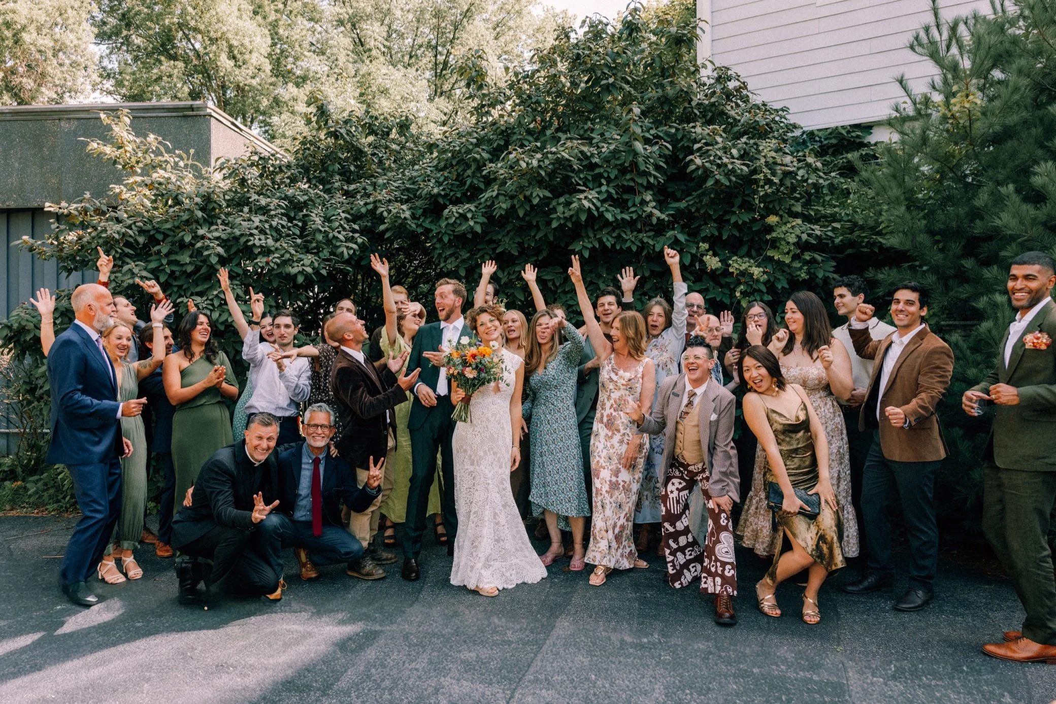  group photo of bride and groom with guests during intimate wedding at The Yard in Beacon, NY 