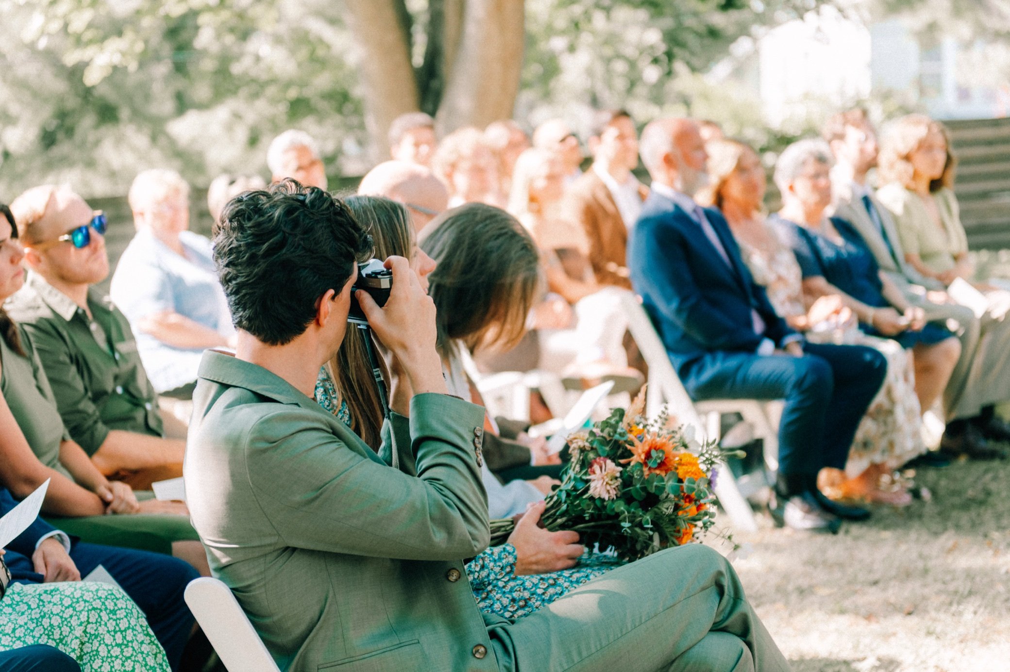  wedding guest takes photo on film camera during ceremony in beacon, ny 