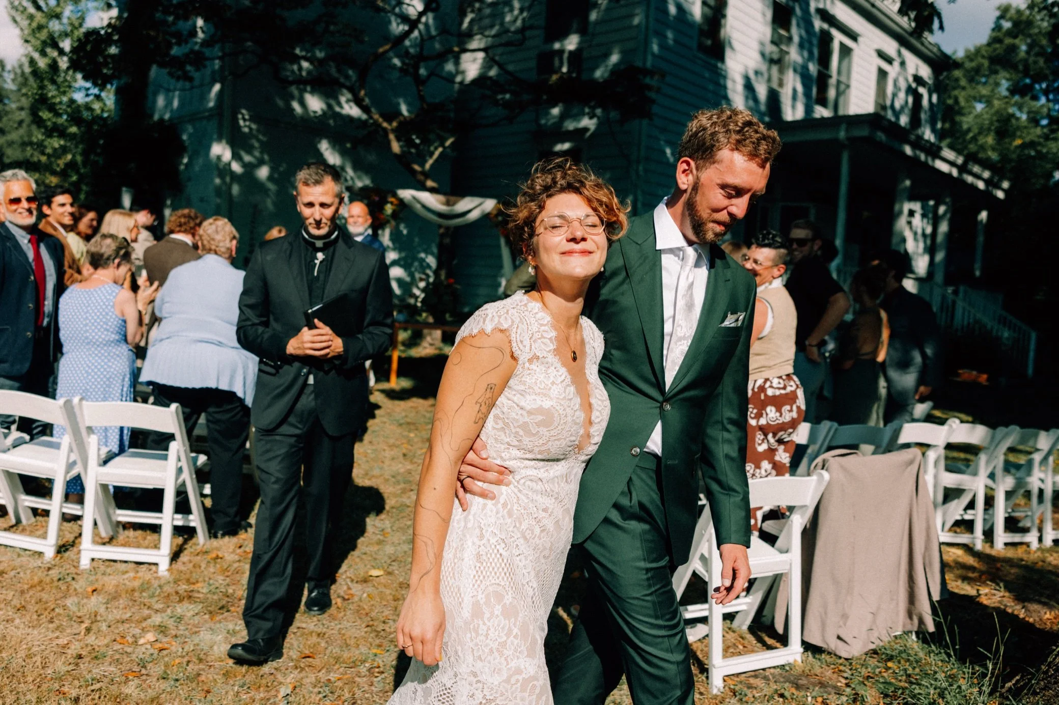  bride and groom walk down the aisle during wedding recessional in the sun at the yard in beacon, ny 