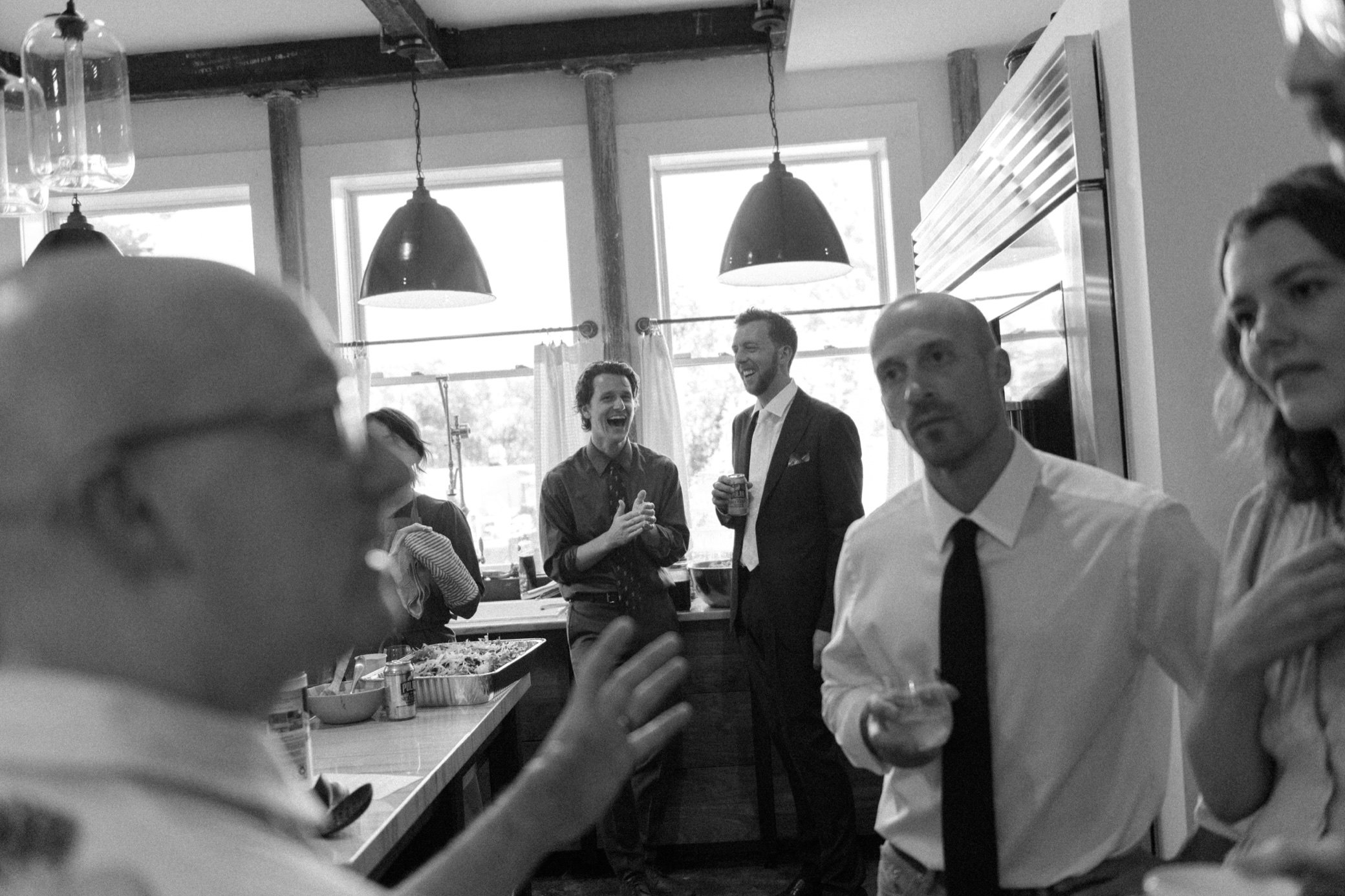  wedding guests converse in the mansion kitchen of the yard in beacon, ny 