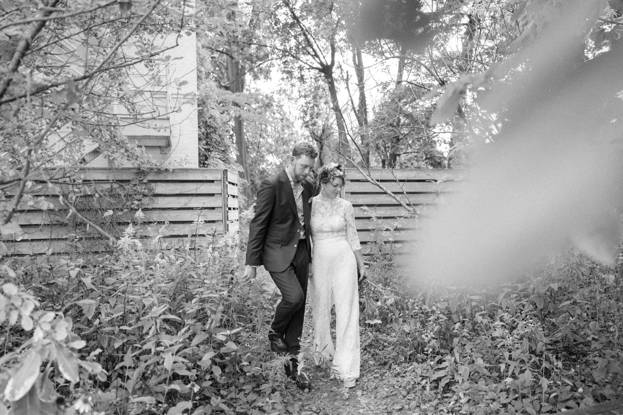  wedding couple walk down a path in the yard of Beacon, ny 