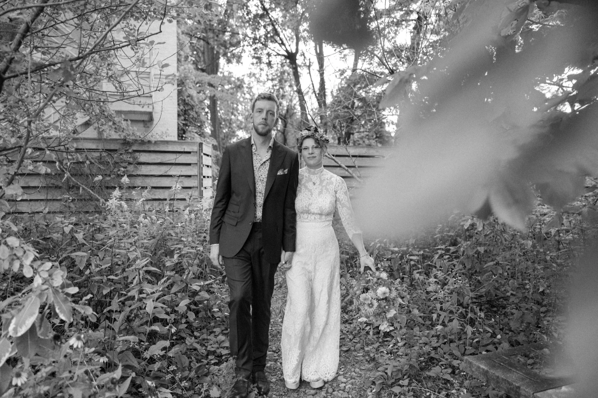  candid photograph of bride and groom walking down a path at the yard in beacon, ny 