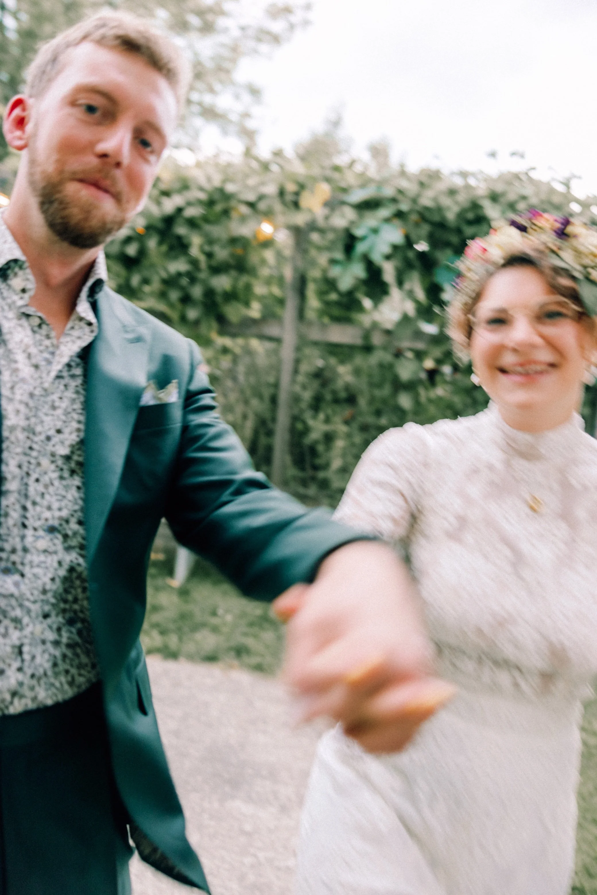  motion blur photograph of bride and groom skipping in the yard wedding venue in beacon, ny 