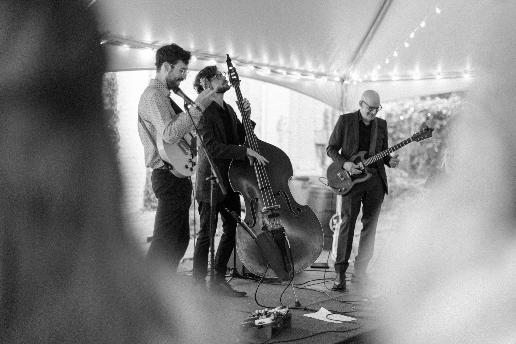  black and white photograph of band playing under tent at the yard in beacon, ny 