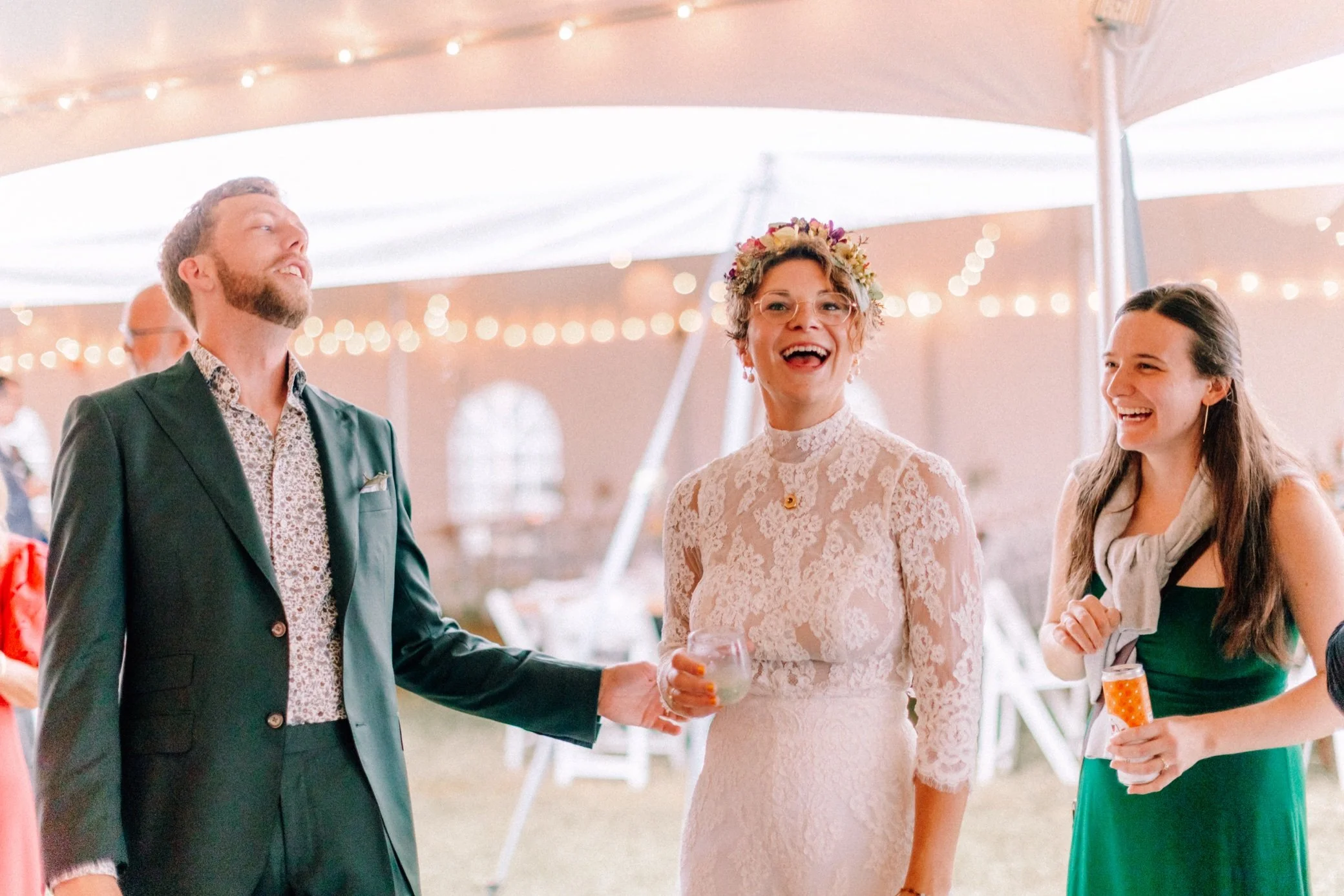  bride and groom laughing under cocktail hour tent at the yard in beacon, ny 