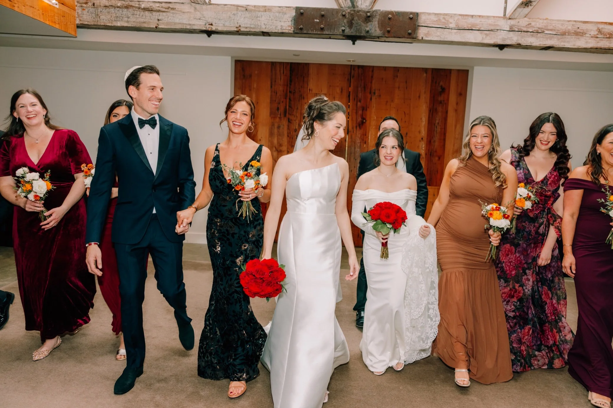  candid photograph of wedding party walking in the roundhouse 