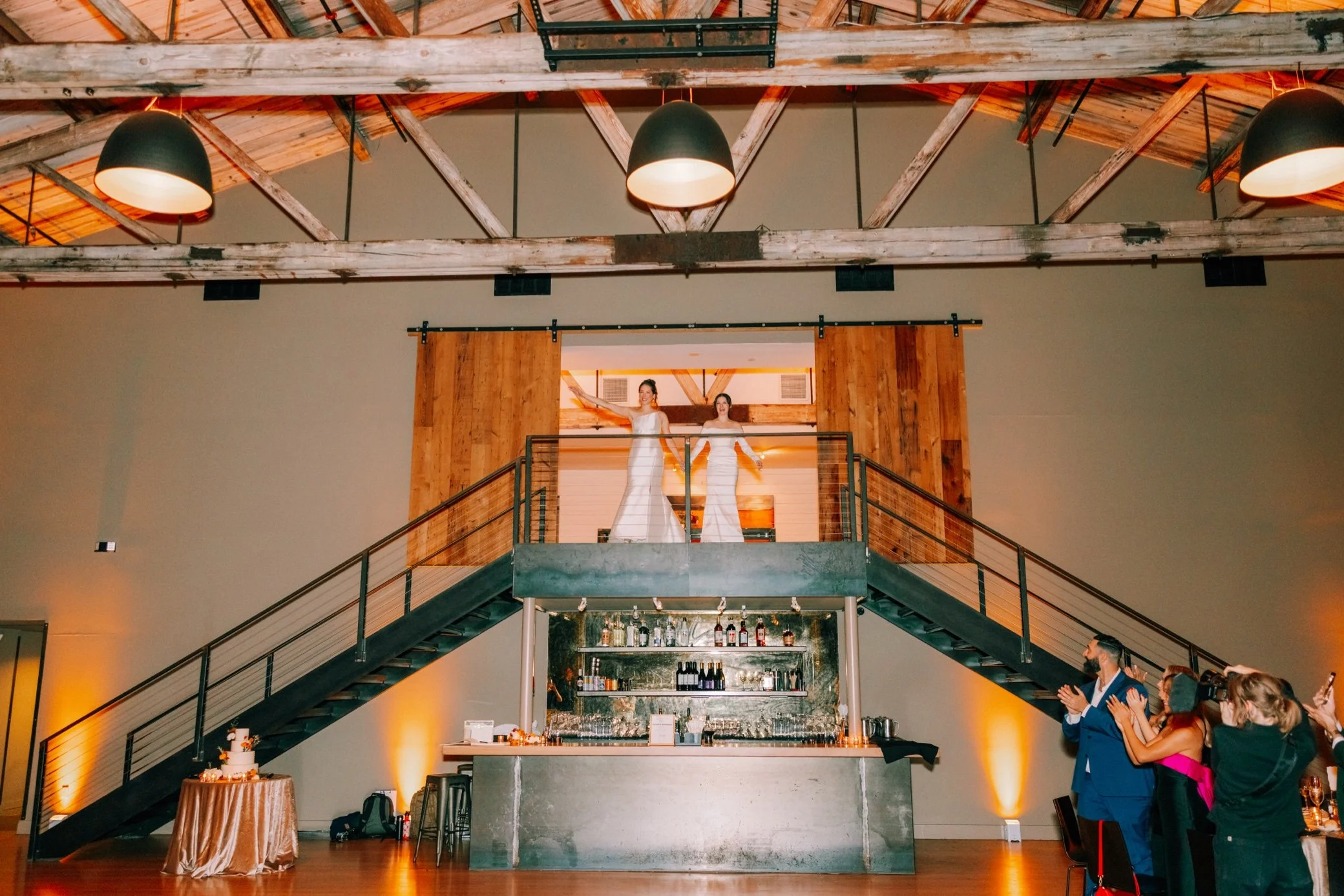  brides during grand entrance through barn doors at the roundhouse 