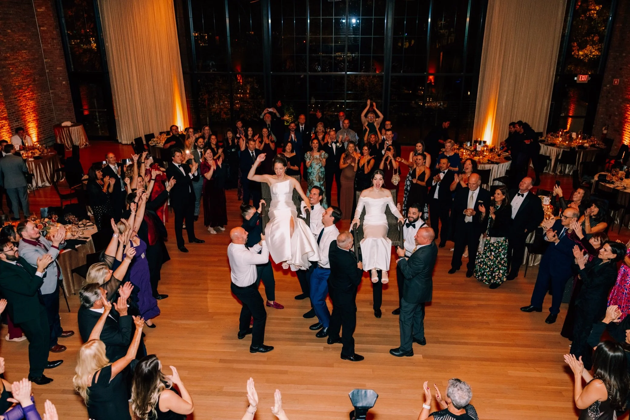  brides on chairs during the hora at the roundhouse 