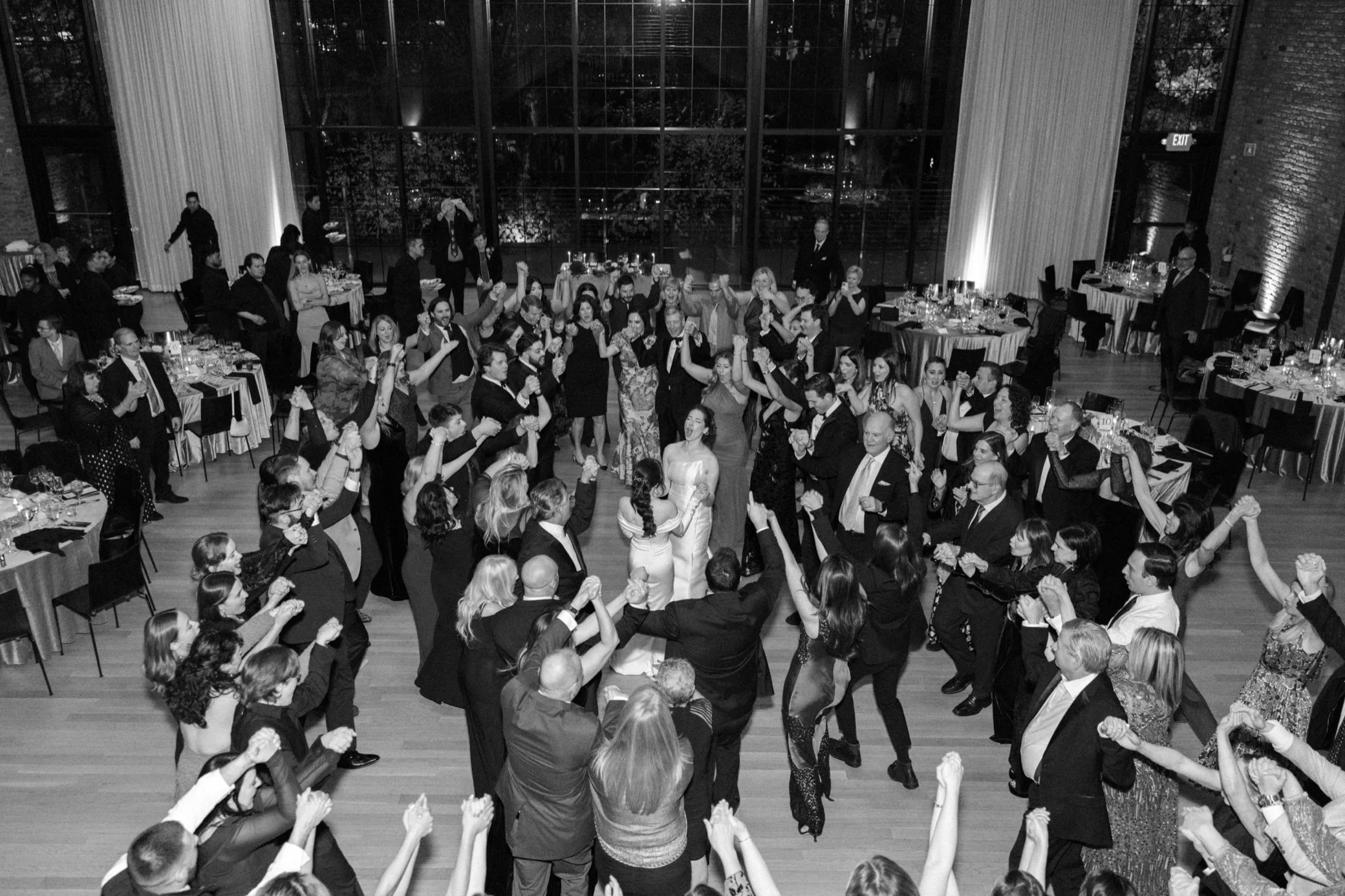  brides in the center of the dance floor hora at the roundhouse 