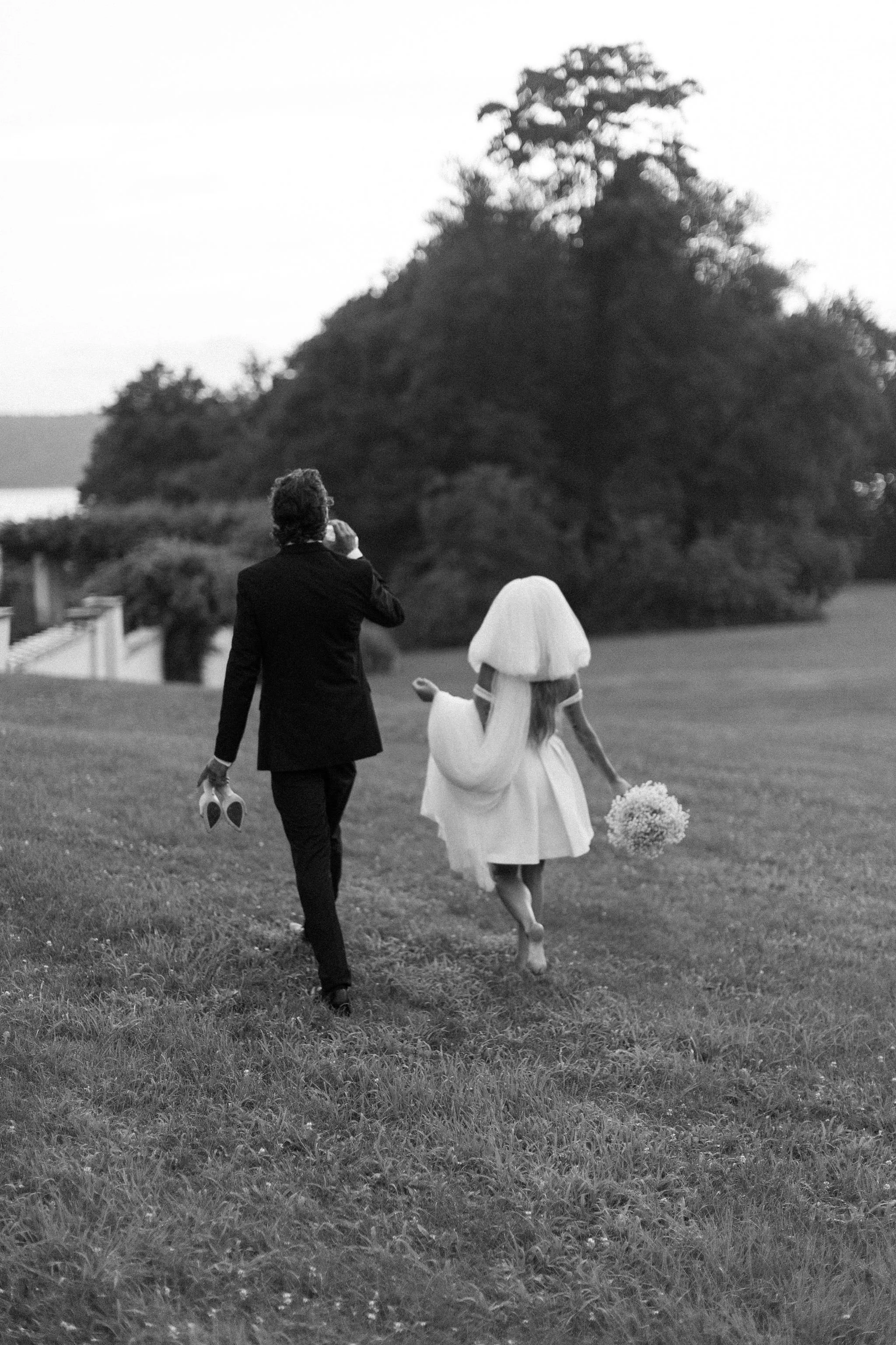 couple walking through grass during their hudson valley elopement