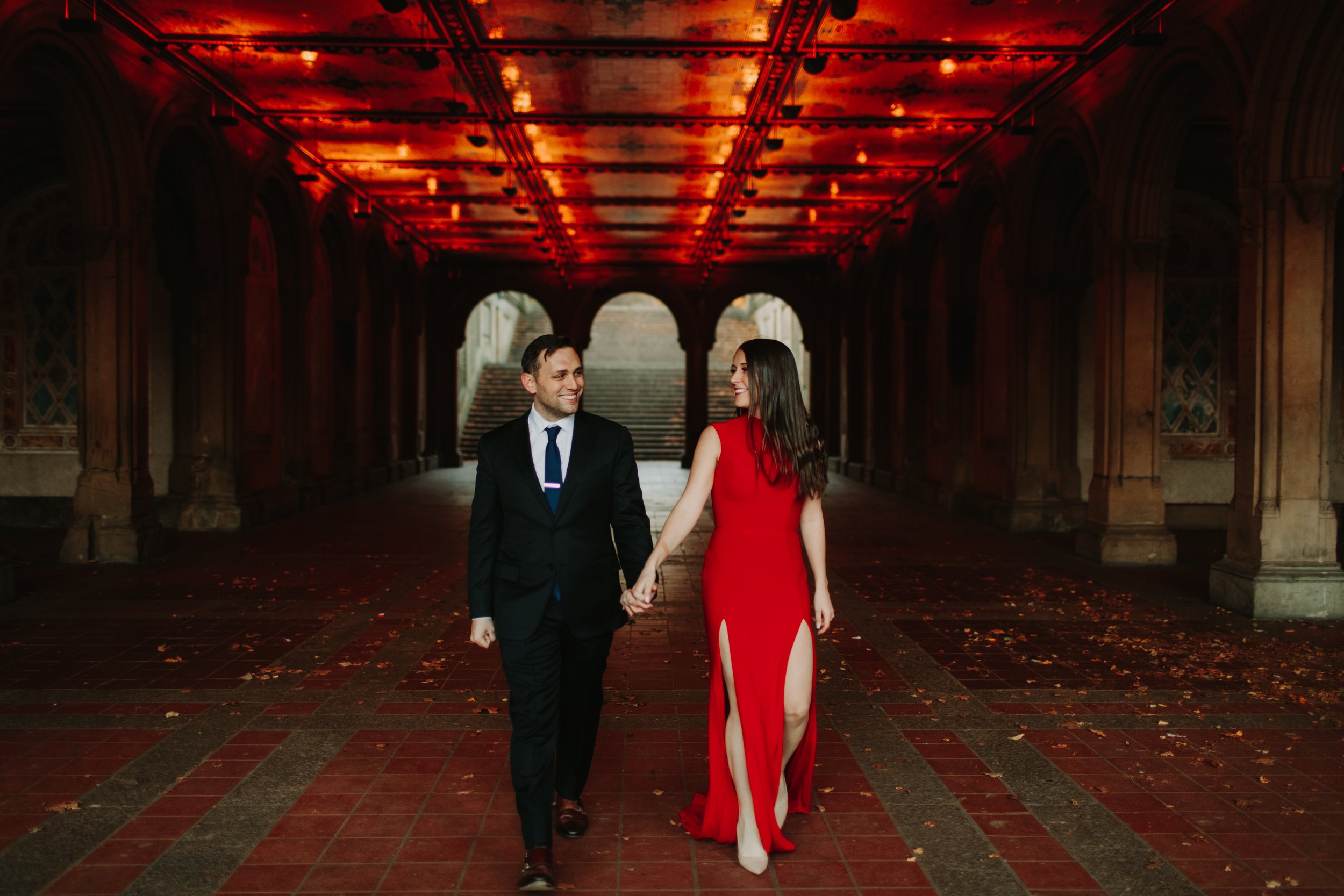 couple walking through Bethesda Terrace during their central park engagement shoot photographs