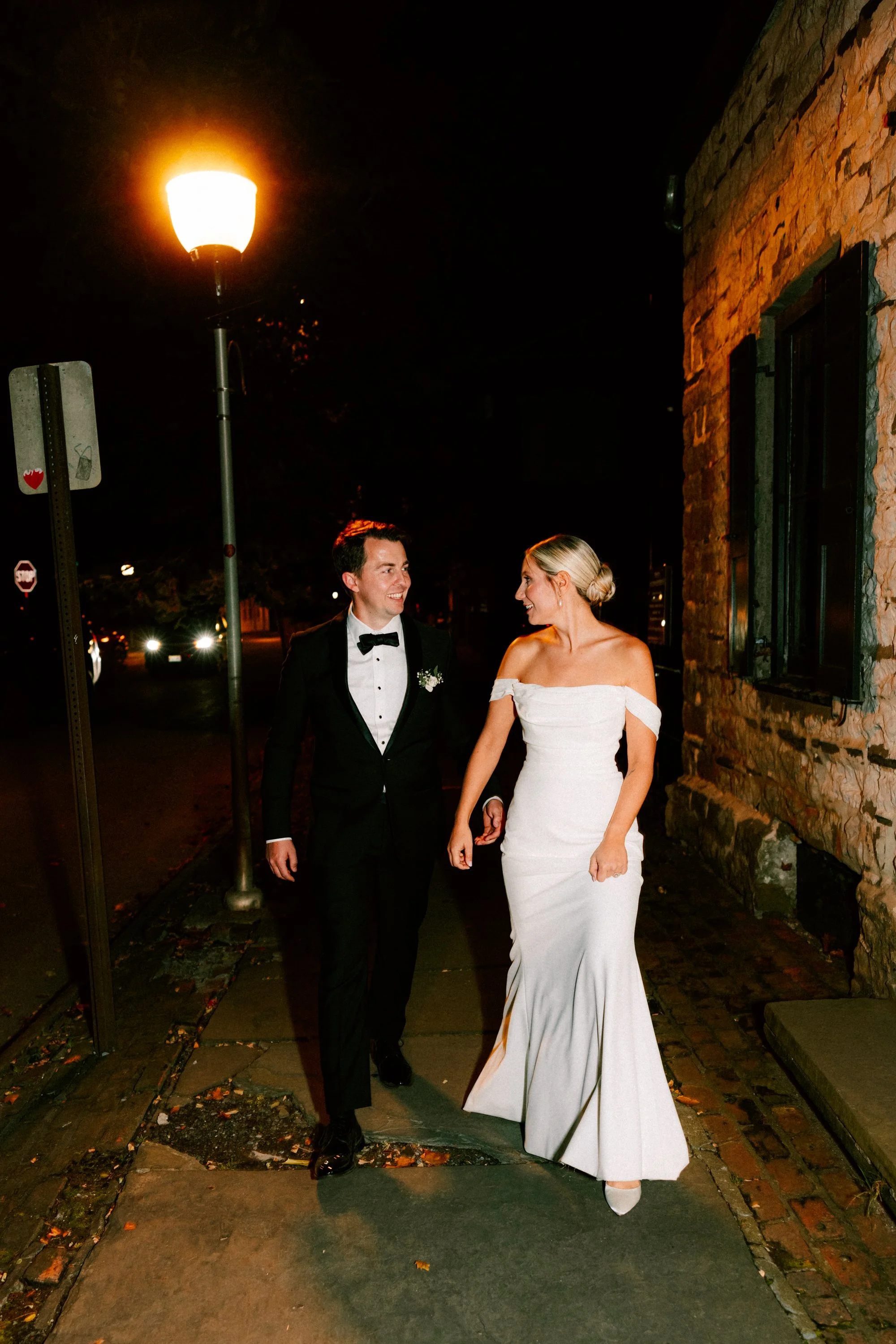 wedding couple walk to their reception at the senate garage