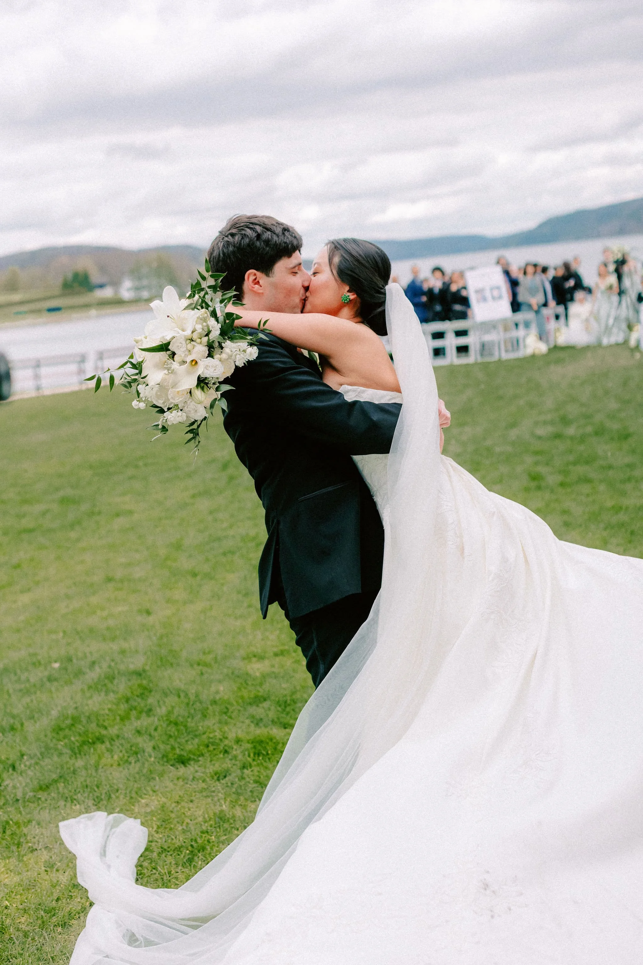 groom lifting and spinning bride after their wedding ceremony at otesaga hotel in cooperstown new york