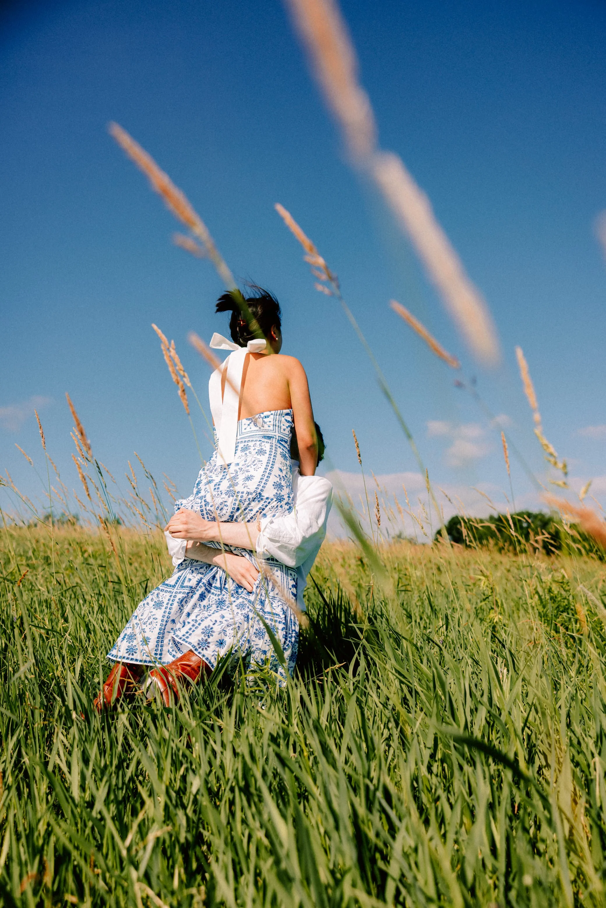 engaged couple dance in a field during their hudson valley engagement photo shoot